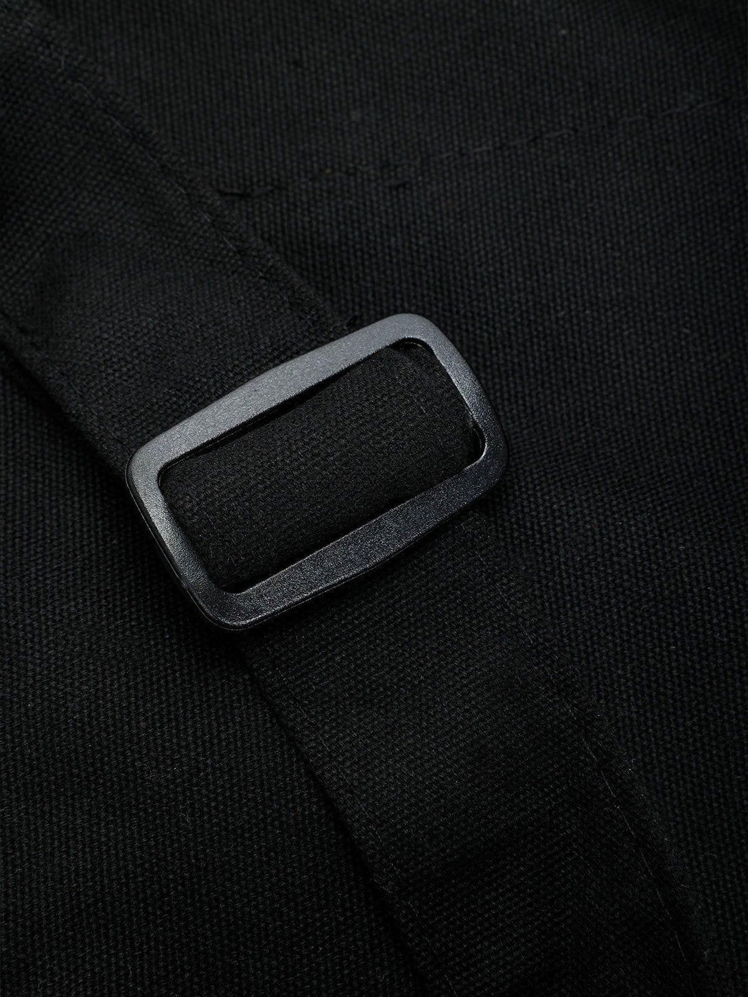 Zoomed-in detail of TALISHKO's black shoulder bag buckle, highlighting its durable design.