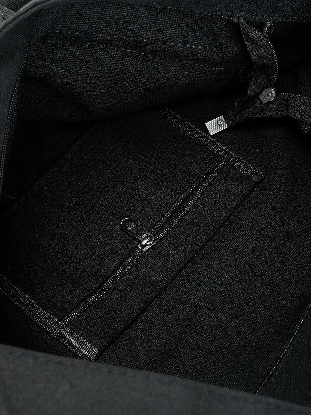 Intricate look inside TALISHKO's shoulder bag, highlighting its spacious pocket and zipper detail.