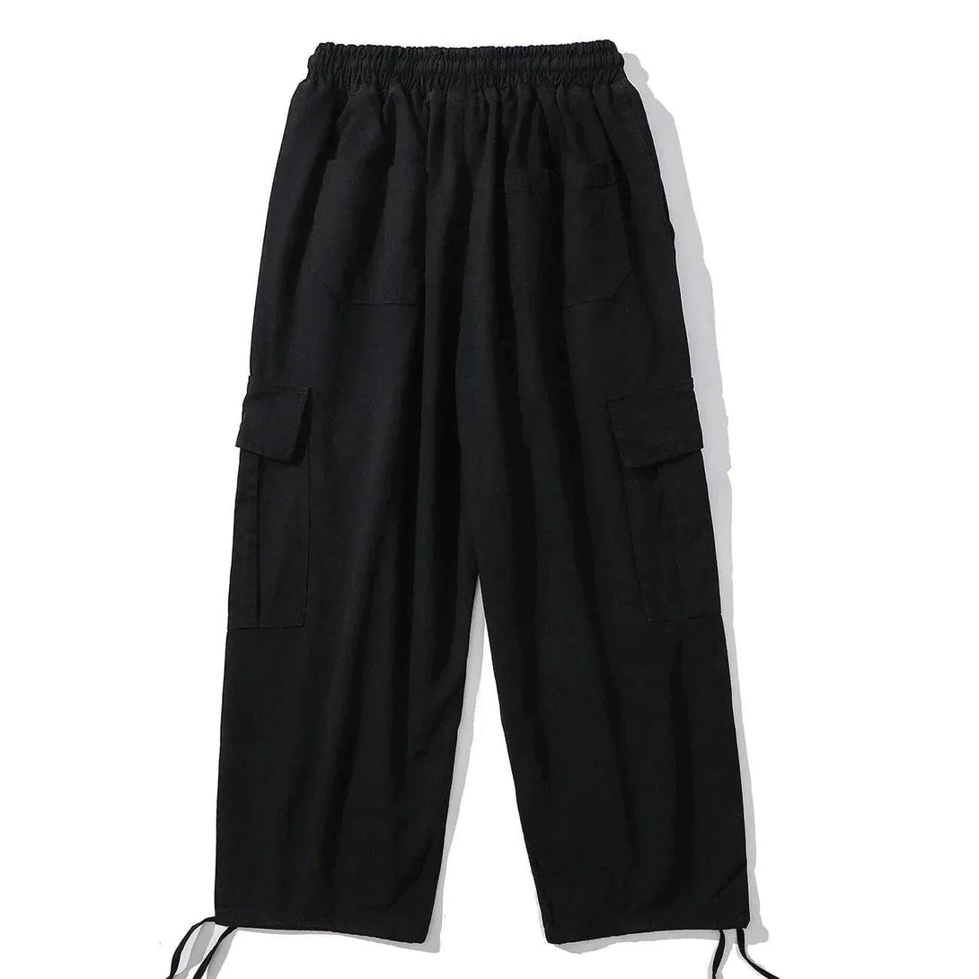 Black cargo pants with large pockets and drawstring cuffs by TALISHKO, showcasing a relaxed fit.
