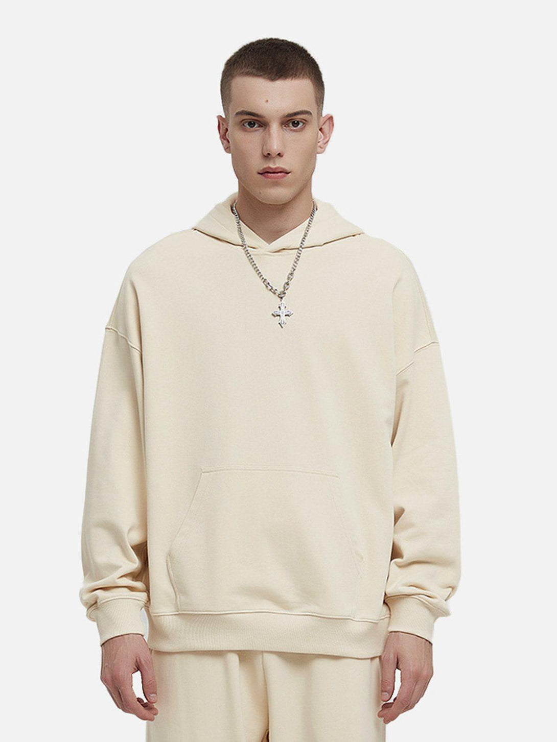 Model wearing TALISHKO solid cotton hoodie in a neutral tone, highlighting casual style.