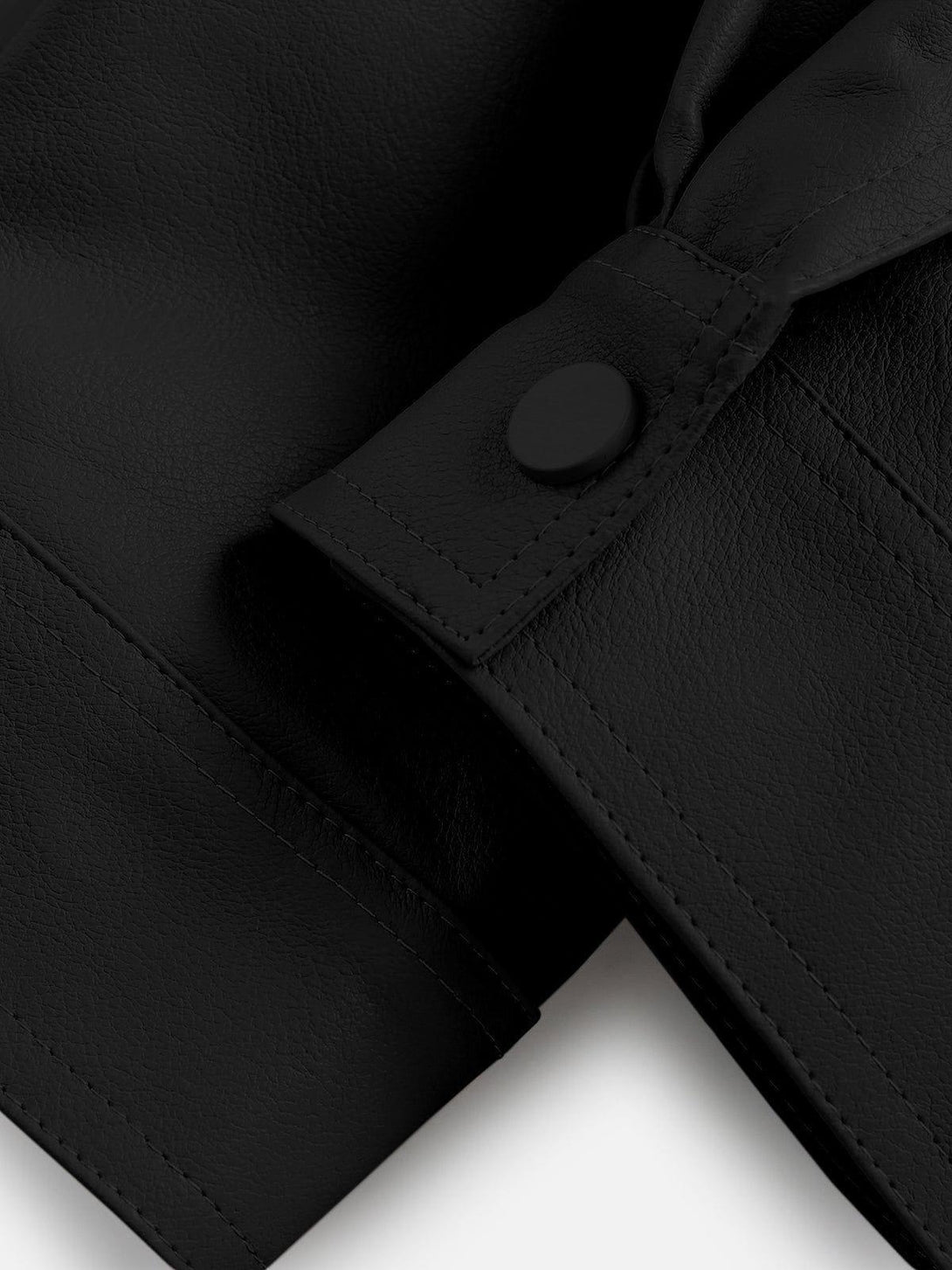 Intricate look at the TALISHKO faux leather jacket's button detail and textured design.