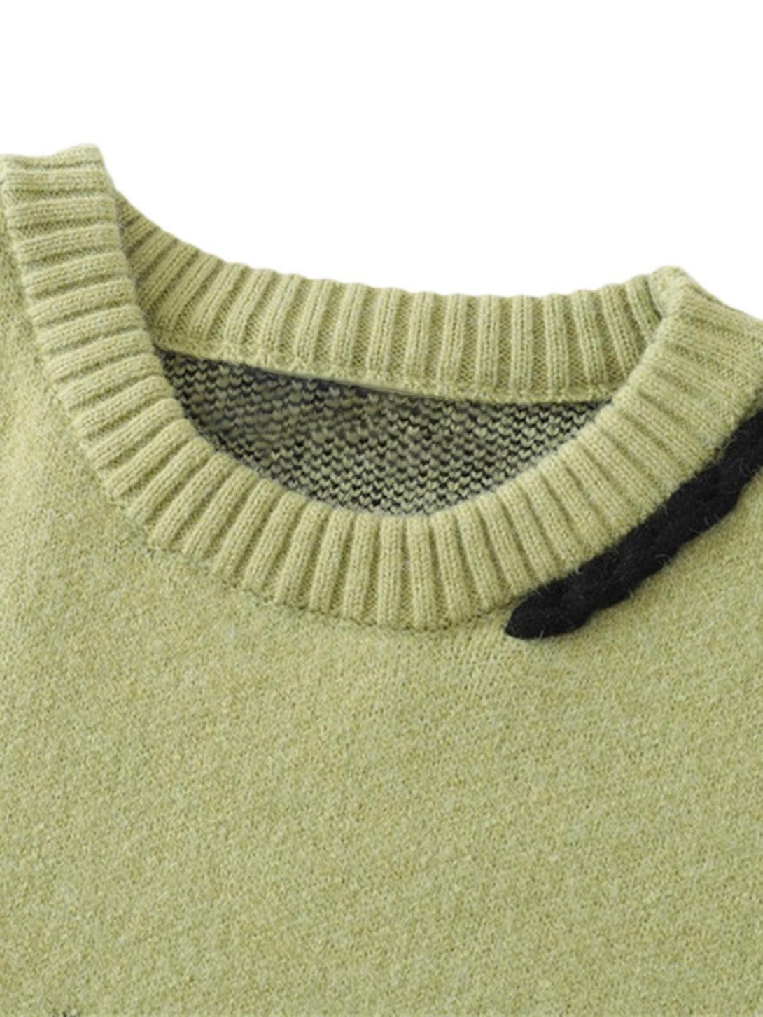 A detailed view of the green oversized sweater's neckline by TALISHKO, highlighting its texture.