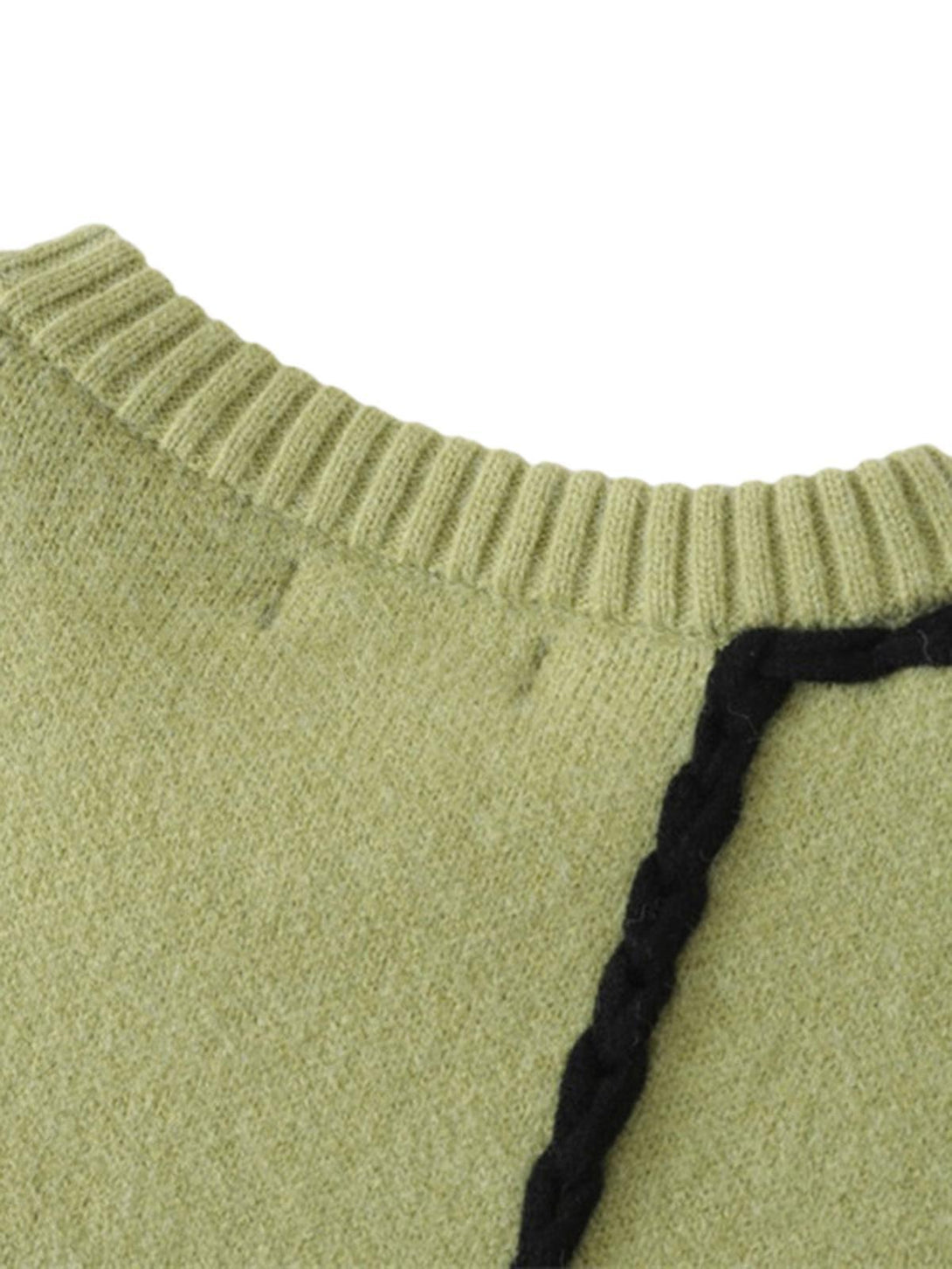 Detailed fabric and stitching of TALISHKO's sweater, emphasizing green texture and black trim.