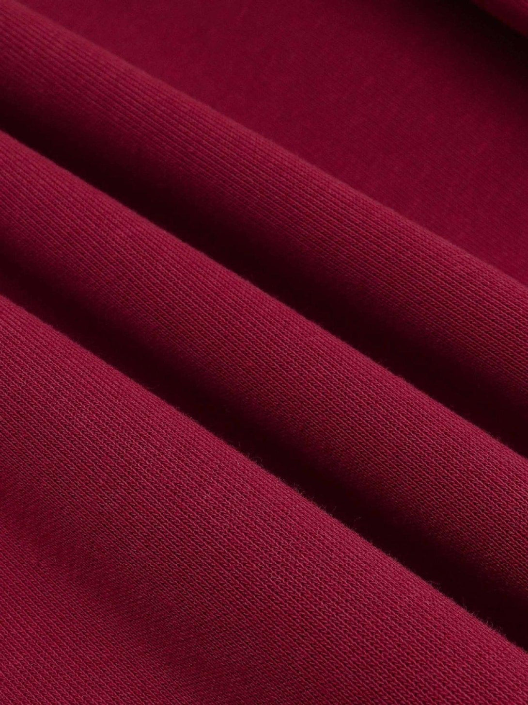 Zoomed-in texture of a red fabric by TALISHKO, highlighting its rich color and soft material.