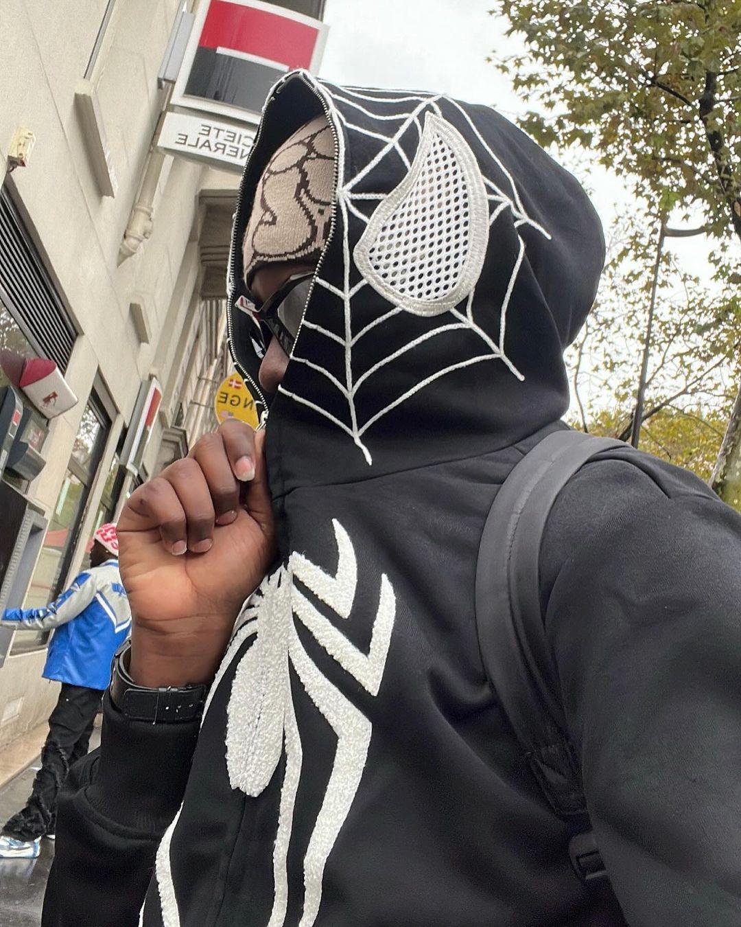 Close-up of the spider web embroidery on a black hoodie by TALISHKO, showcasing unique style.