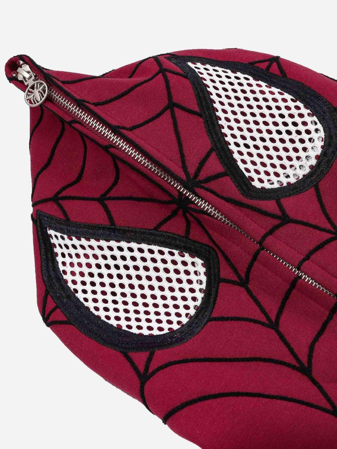 A close-up of the spider web embroidery and eye details on a red hoodie by TALISHKO.