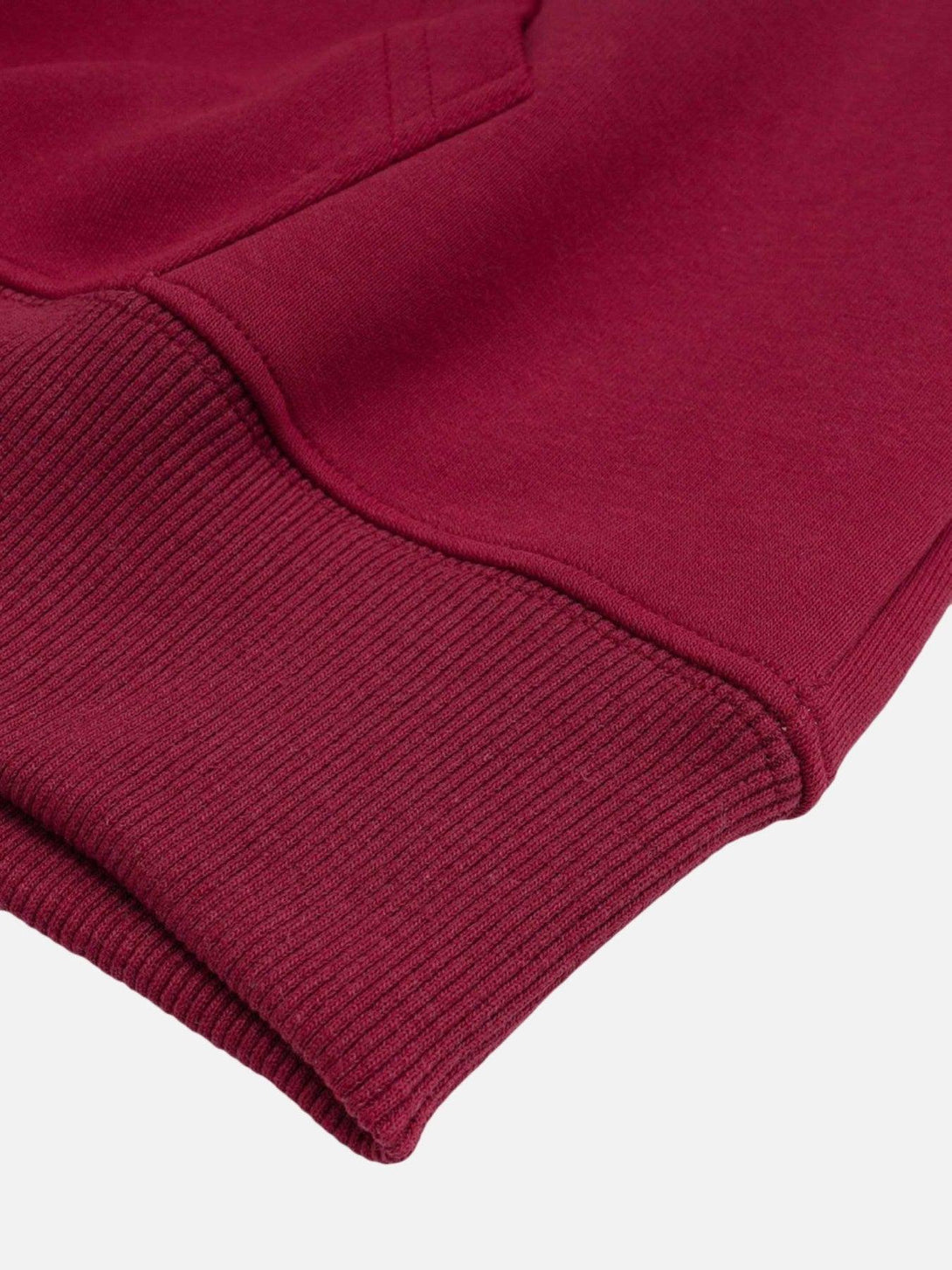 Detailed fabric and stitching of a red hoodie by TALISHKO, highlighting its soft texture.