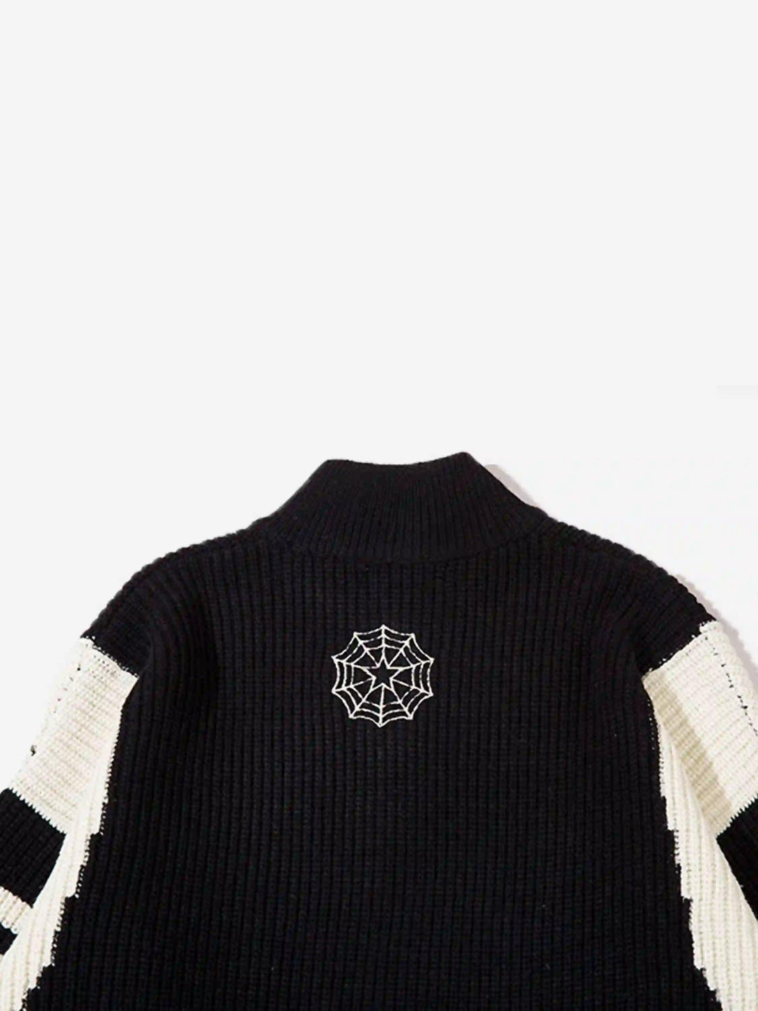 Back view of TALISHKO's black cardigan with a spider web detail, showcasing unique design.
