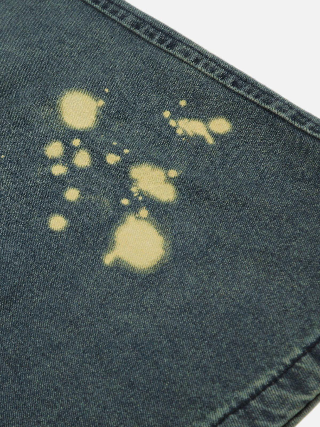 Intricate look at splash-ink wash on TALISHKO baggy jeans, showcasing unique texture and style.