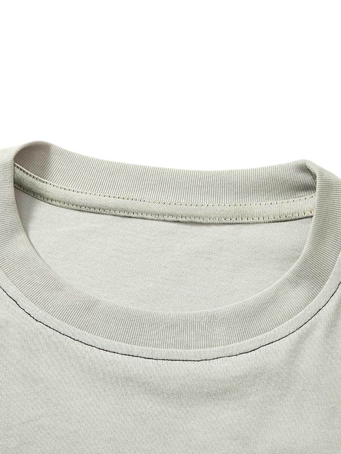 Detailed fabric and stitching of TALISHKO's spliced deconstruction print T-shirt neckline.