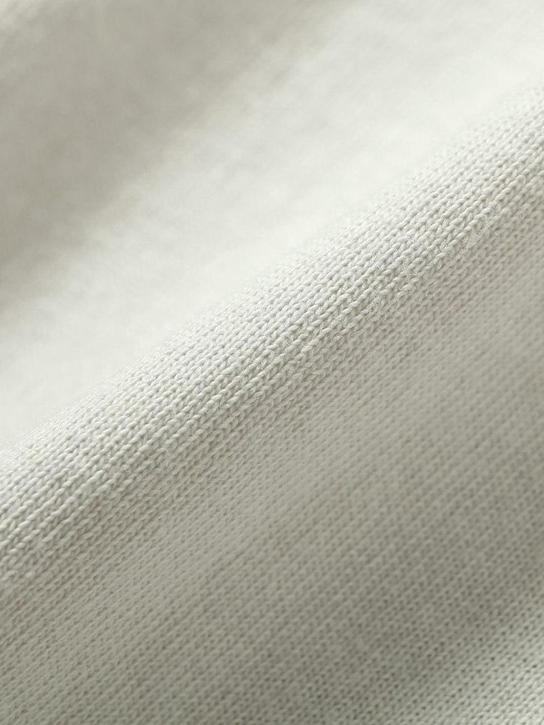 Texture and pattern showcased in TALISHKO's spliced deconstruction print T-shirt fabric.