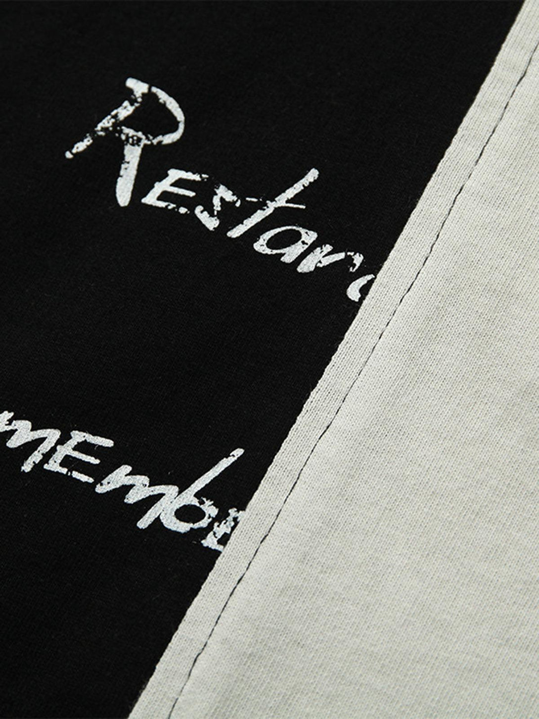 A close-up of TALISHKO's spliced deconstruction print T-shirt, highlighting unique textures.