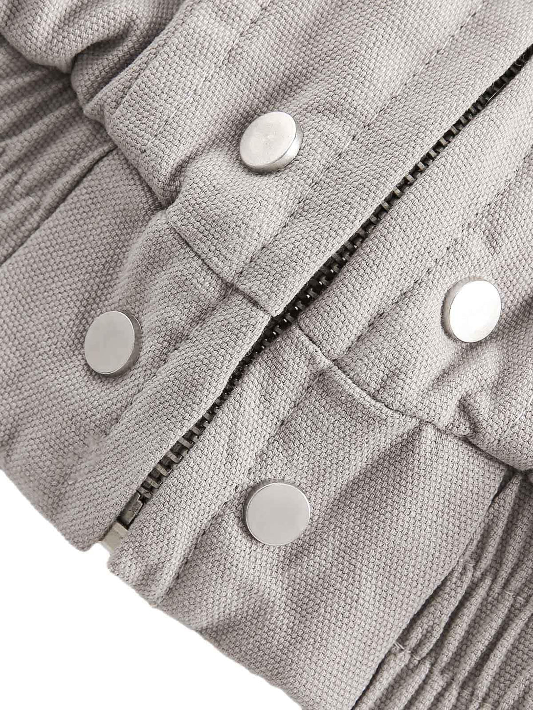 Intricate look at TALISHKO's quilted jacket zipper and snap buttons, highlighting craftsmanship.