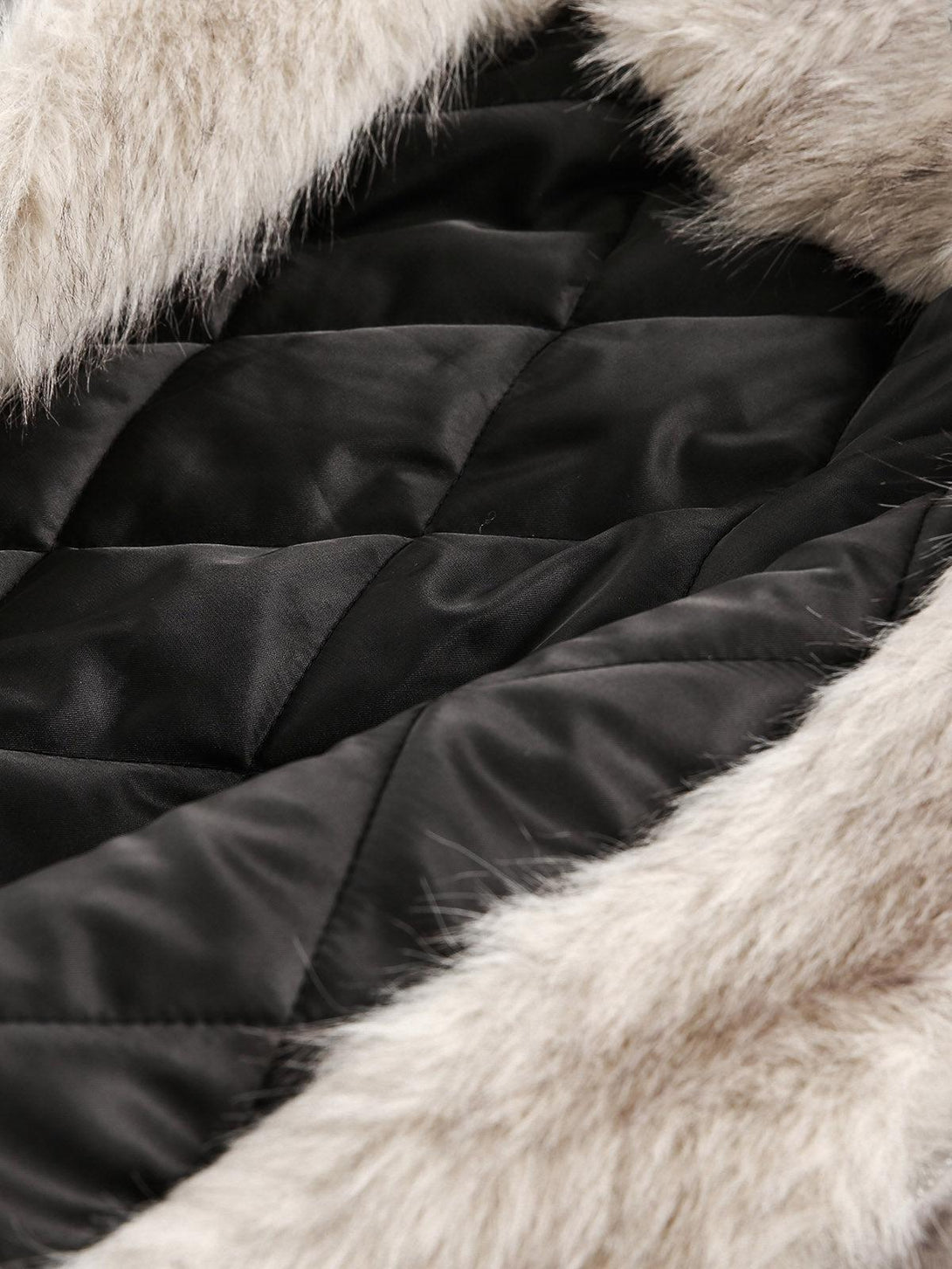 A detailed view of TALISHKO's quilted jacket fur lining, highlighting its plush texture.