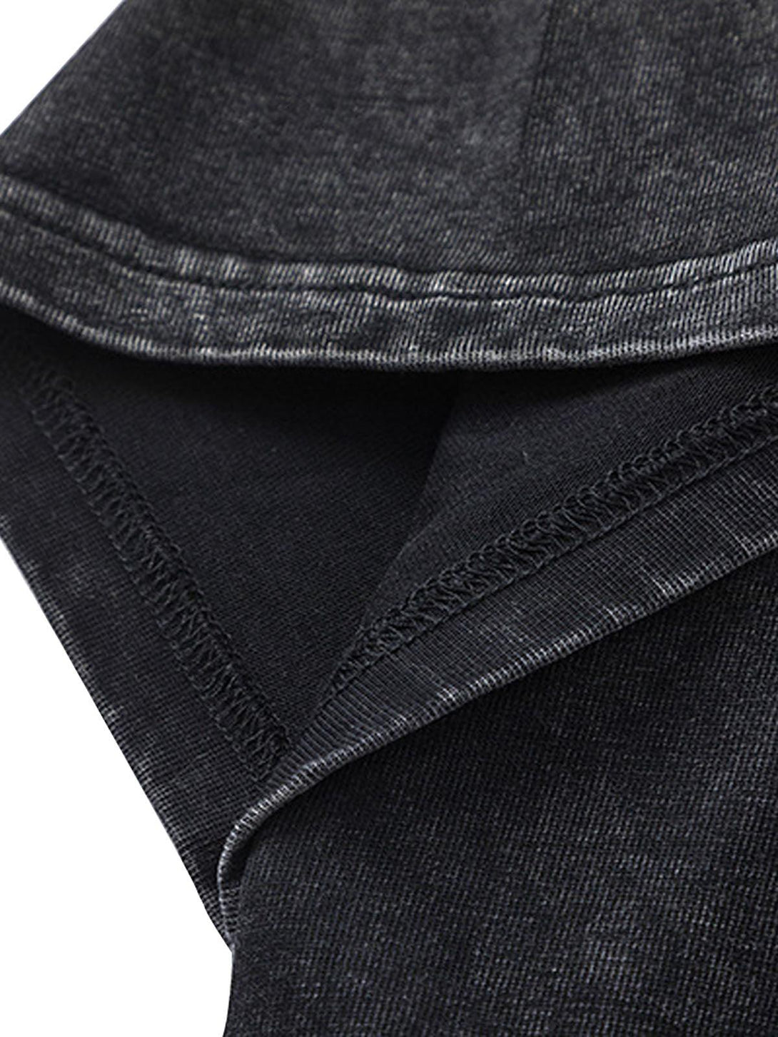 Detailed fabric and stitching of a black TALISHKO split raw edge short sleeve T-shirt.