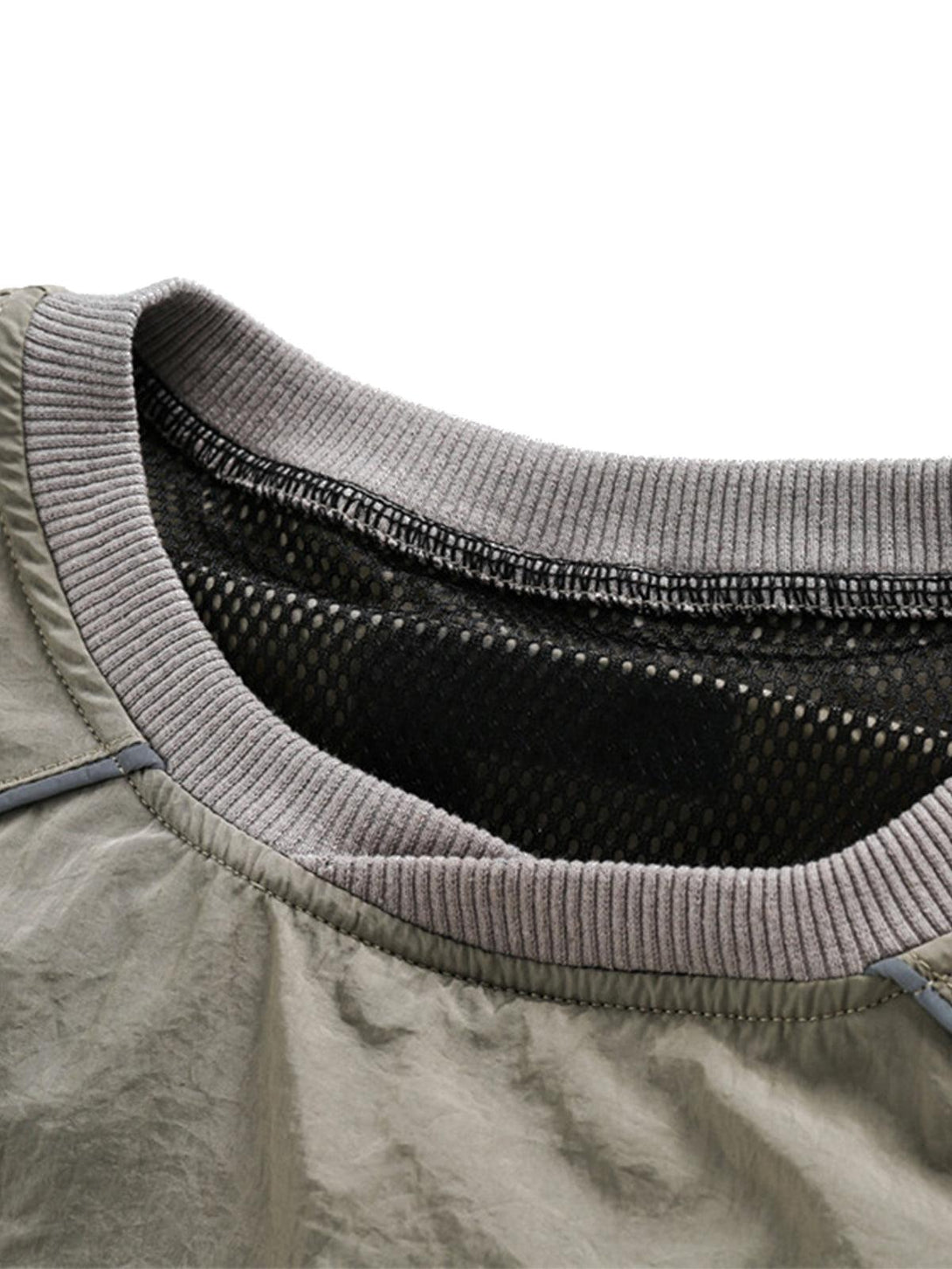 Detailed view of TALISHKO sporty T-shirt neckline with ribbed trim and mesh lining.