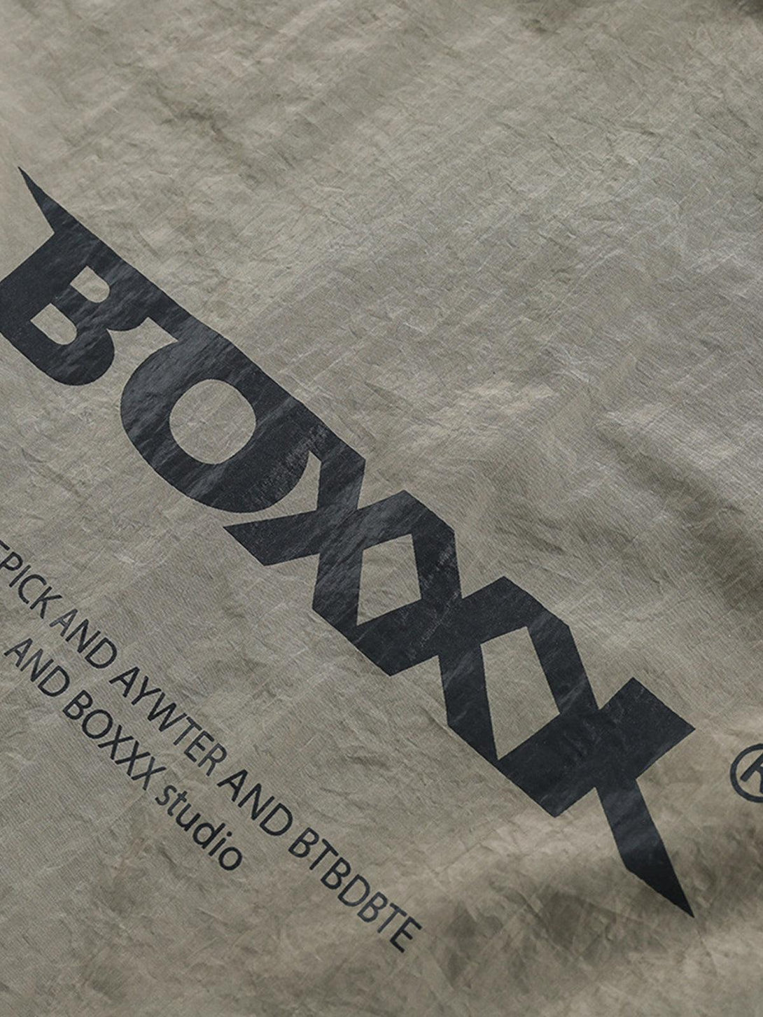 Zoomed-in texture of TALISHKO sporty outdoor long-sleeve T-shirt fabric and logo design.