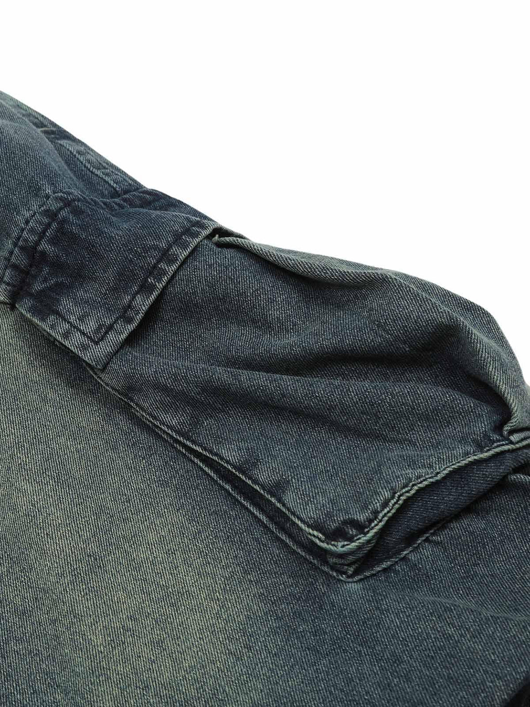 Detailed fabric and stitching of TALISHKO spray-painted cargo jeans, showcasing unique pleats.