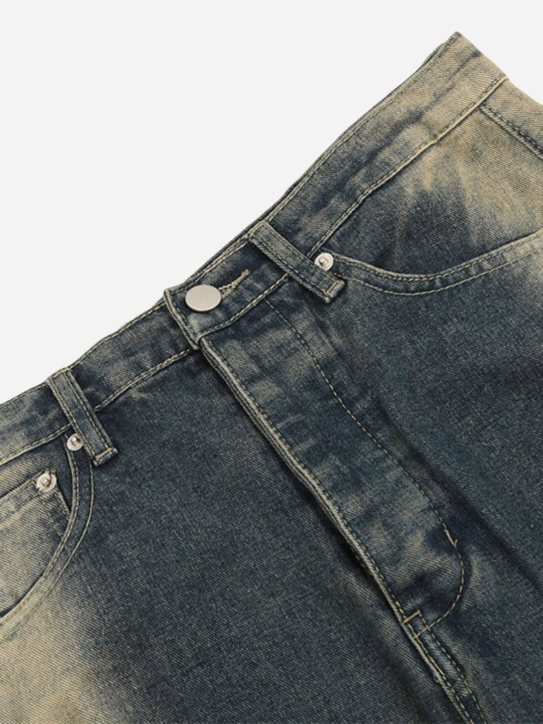A detailed view of TALISHKO's sprayed gradient wide-leg jeans, showcasing the unique denim texture.