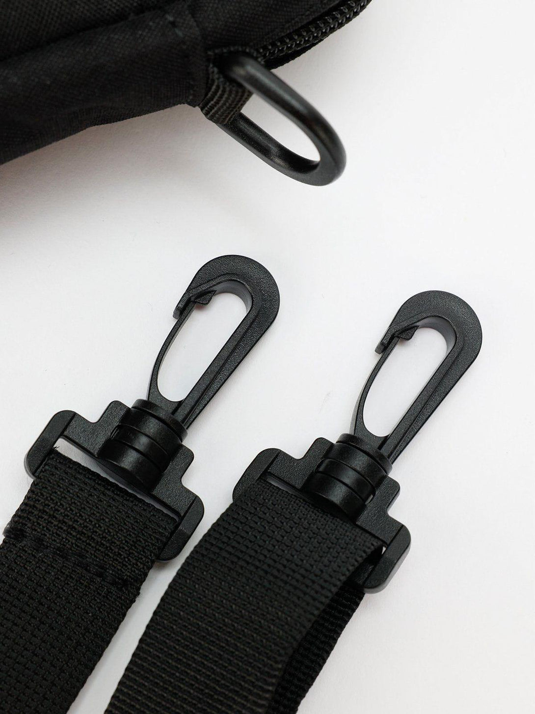 Close-up of TALISHKO bag's black strap hooks, highlighting durable design details.