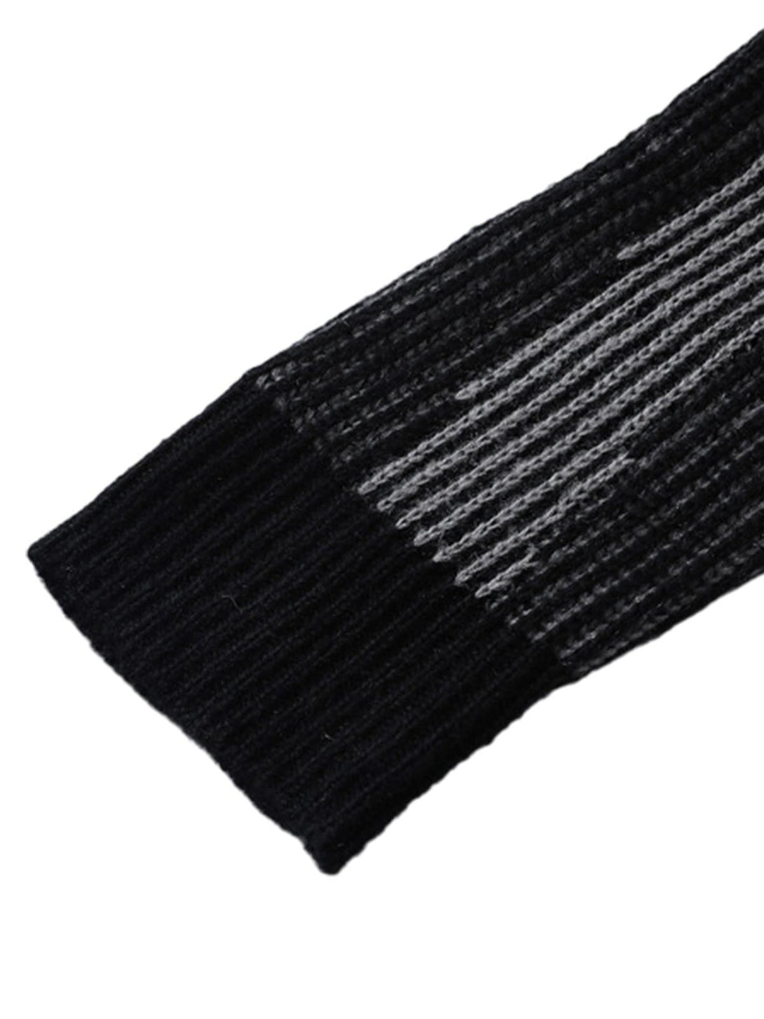 Zoomed-in texture of TALISHKO's sweater, highlighting the intricate knit pattern and ribbed cuff.
