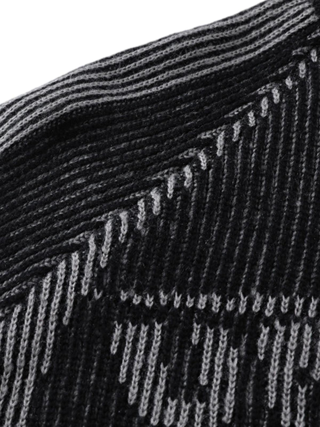 Texture and pattern showcased in TALISHKO's sweater, highlighting intricate knit details.