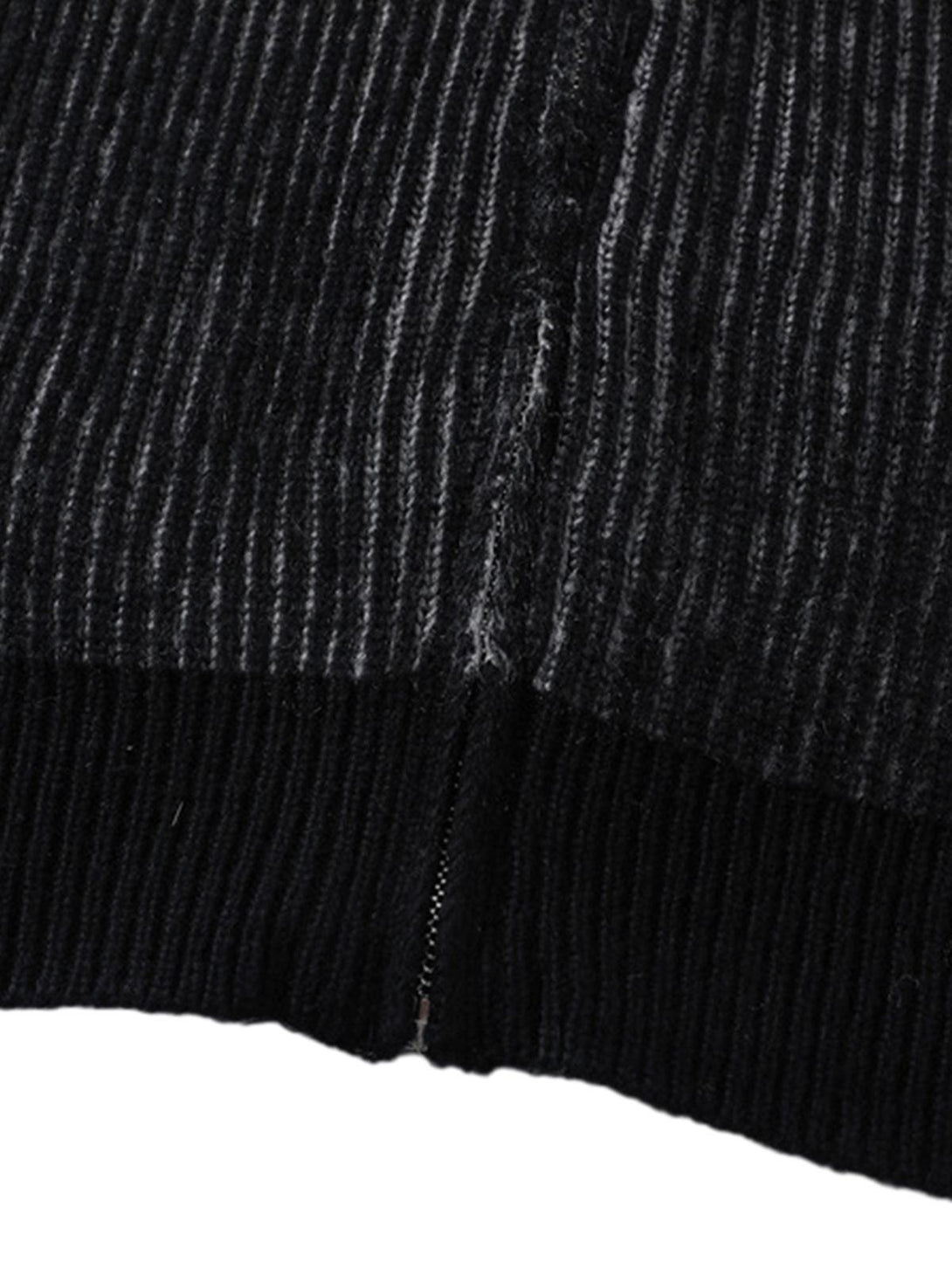 A tight crop highlighting the ribbed texture and stitching detail on TALISHKO's sweater.
