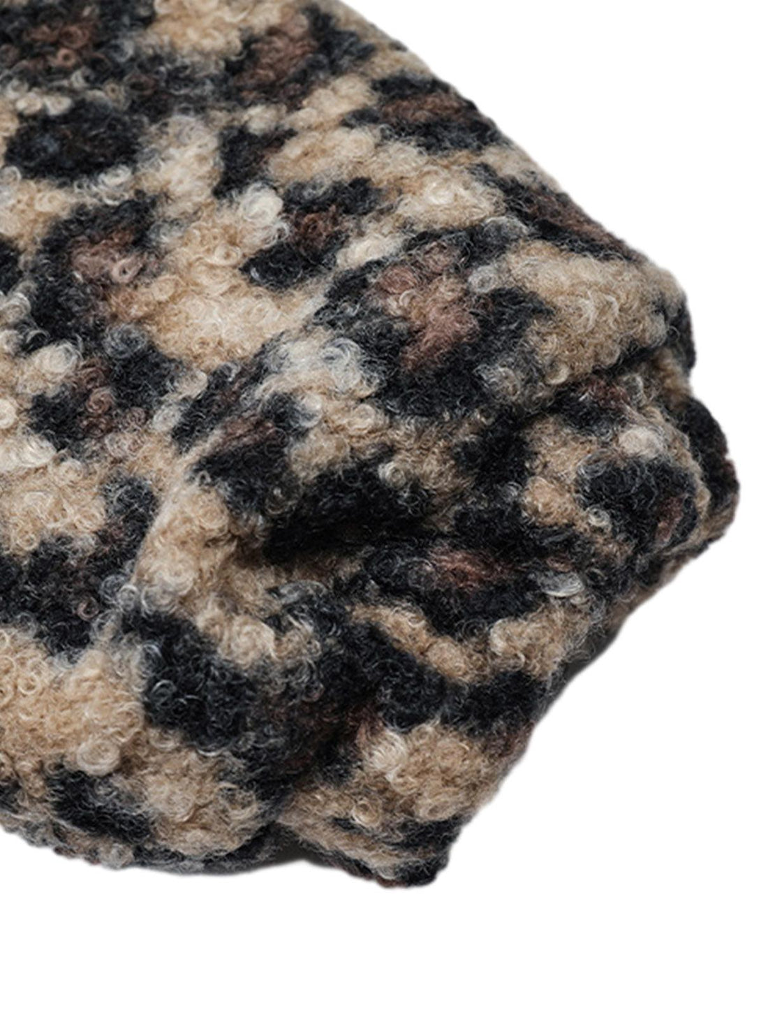 Focusing on the textured fleece of TALISHKO's cheetah print jacket, showcasing its cozy design.