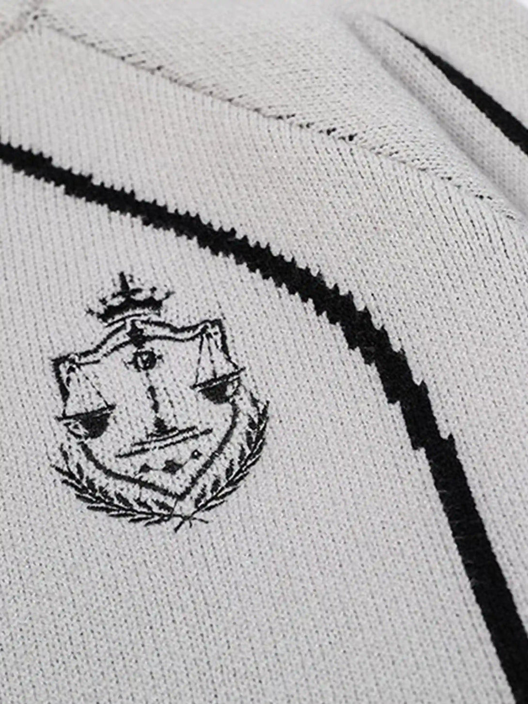 Intricate look at the emblem detail on a TALISHKO cardigan, showcasing fine stitching and texture.