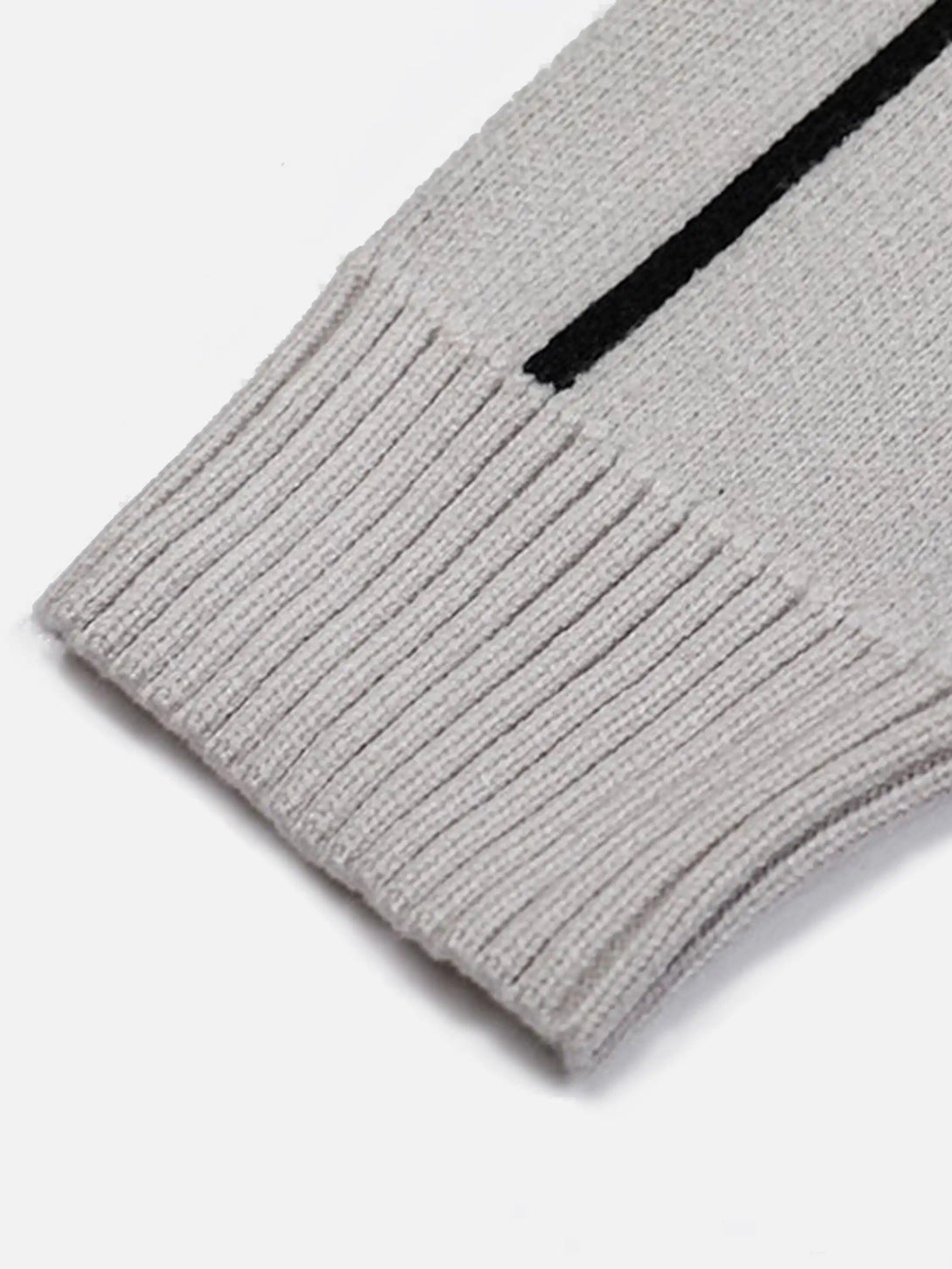 Ribbed cuff detail of a TALISHKO cardigan, highlighting the textured knit and sleek design.