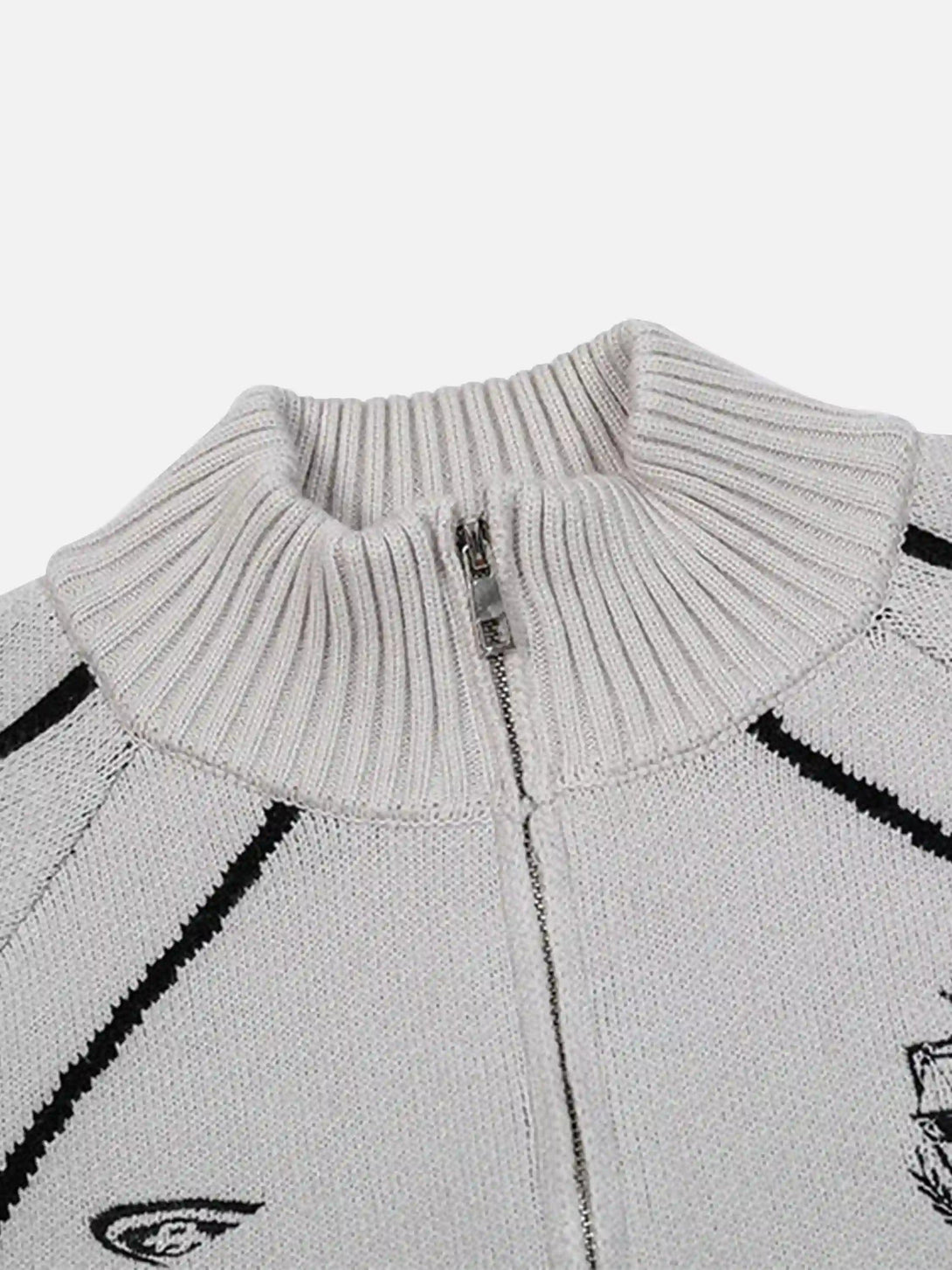 A detailed view of a TALISHKO cardigan's ribbed stand collar and zip, highlighting its texture.