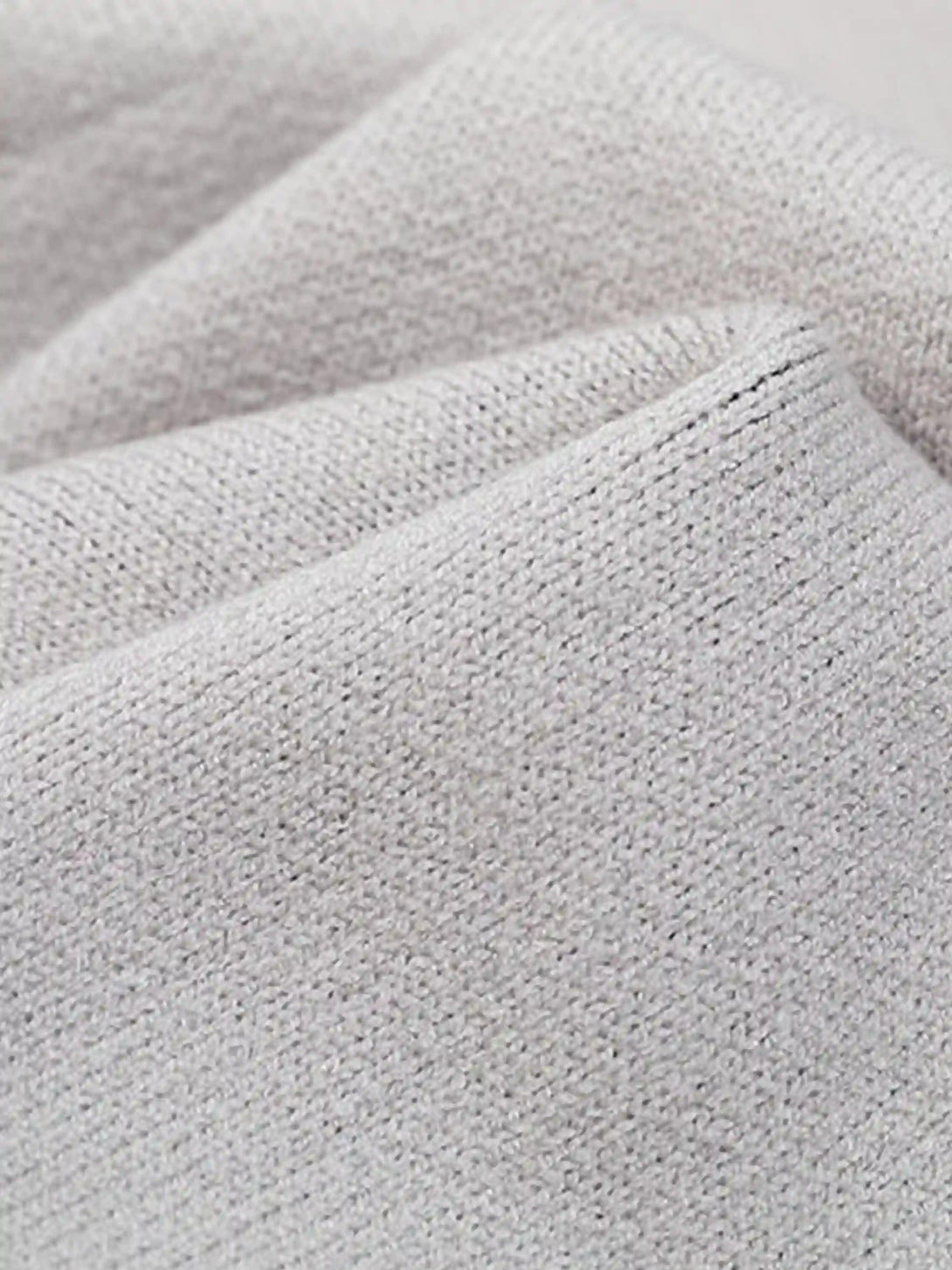 "Texture and pattern showcased in a TALISHKO cardigan, highlighting its intricate knit design."