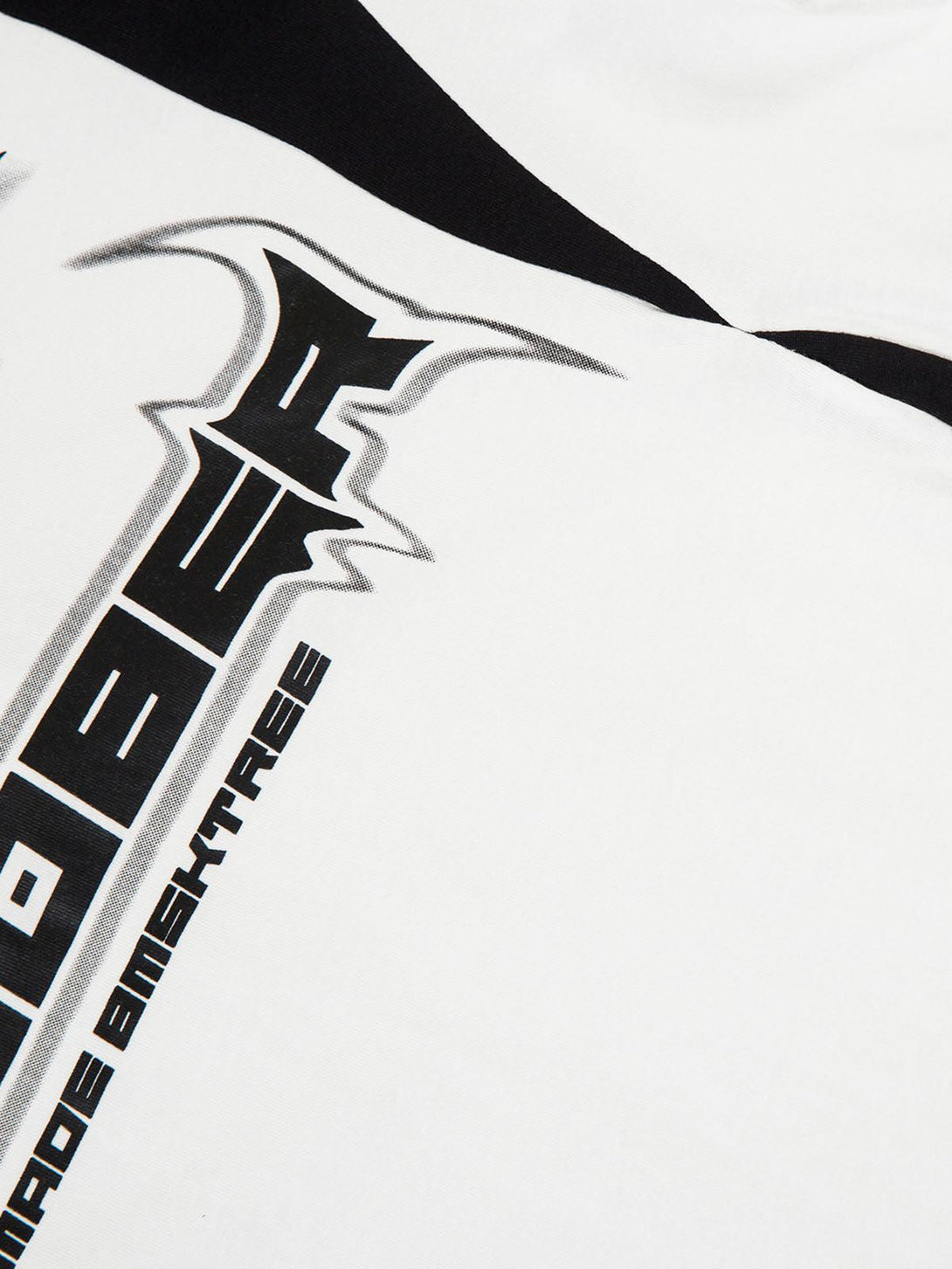 Intricate look at TALISHKO's star-themed graphics and bold color-blocking on a long sleeve shirt.