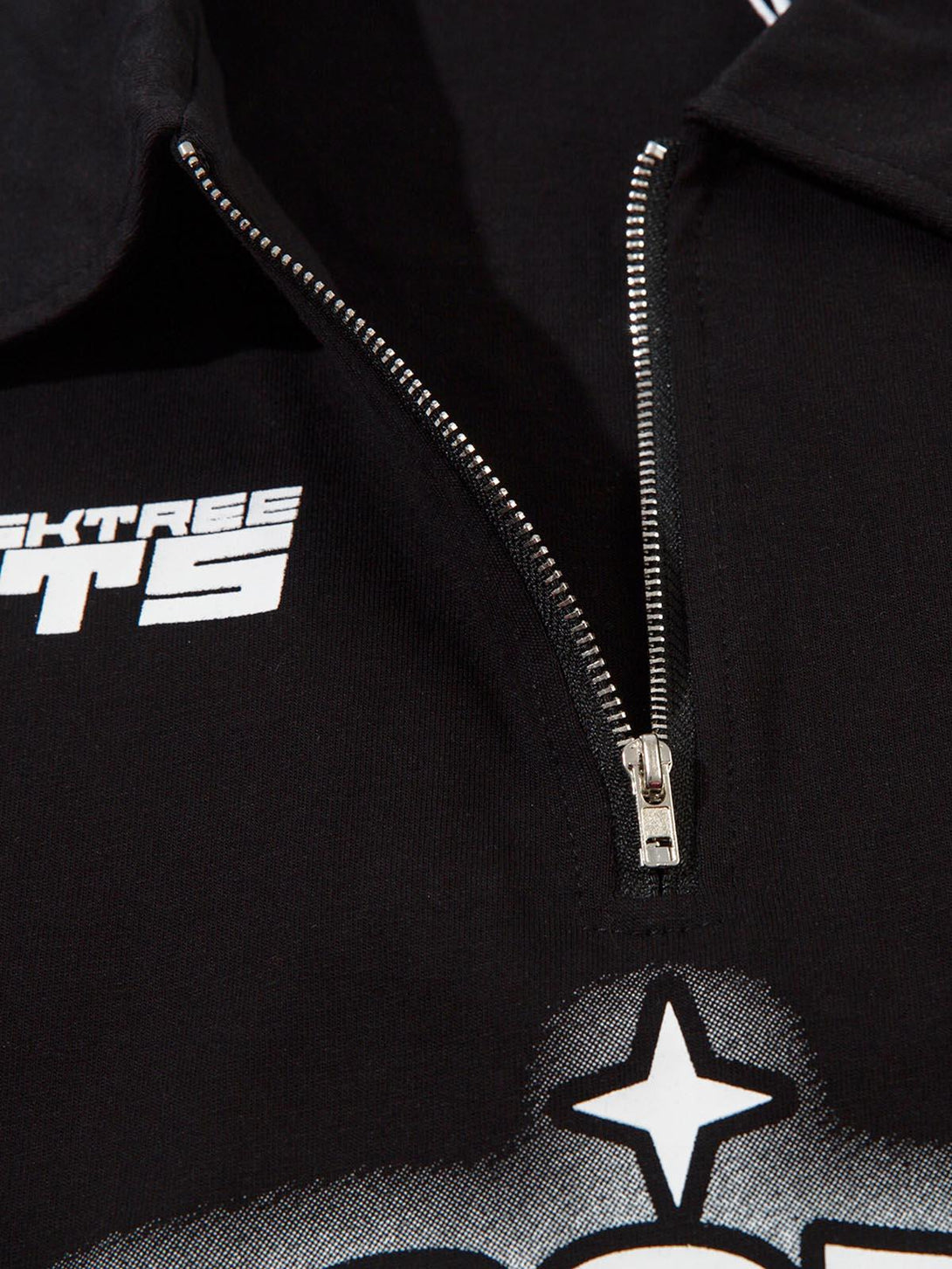 A detailed look at the TALISHKO quarter zipper shirt, highlighting star graphics and zipper design.