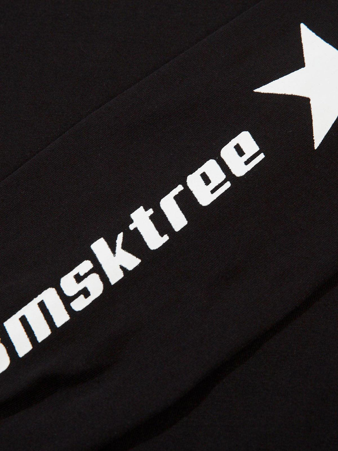 A tight crop highlighting the star graphic and bold lettering on TALISHKO's black shirt.