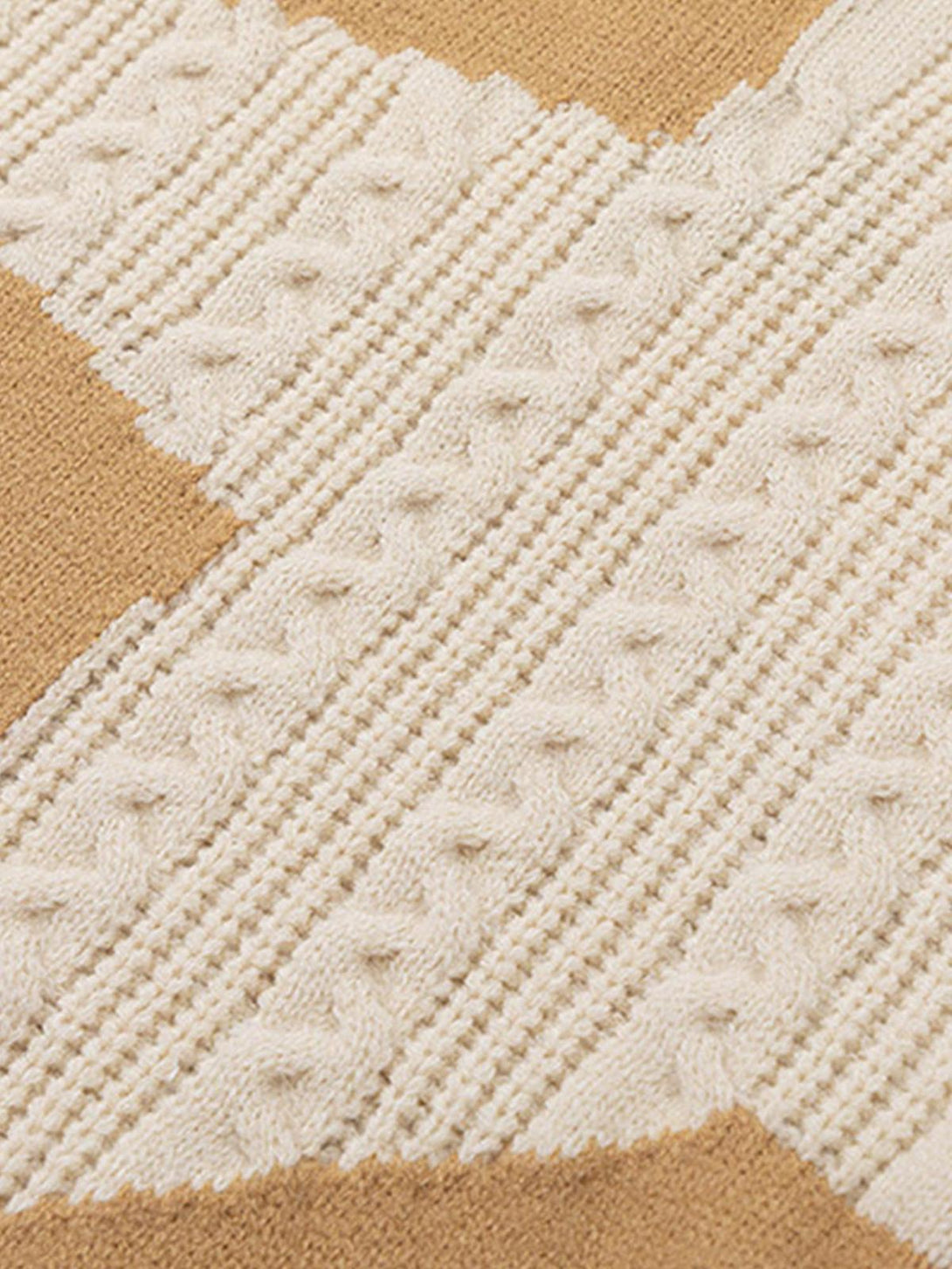 Intricate look at cable knit texture on a beige sweater by TALISHKO.