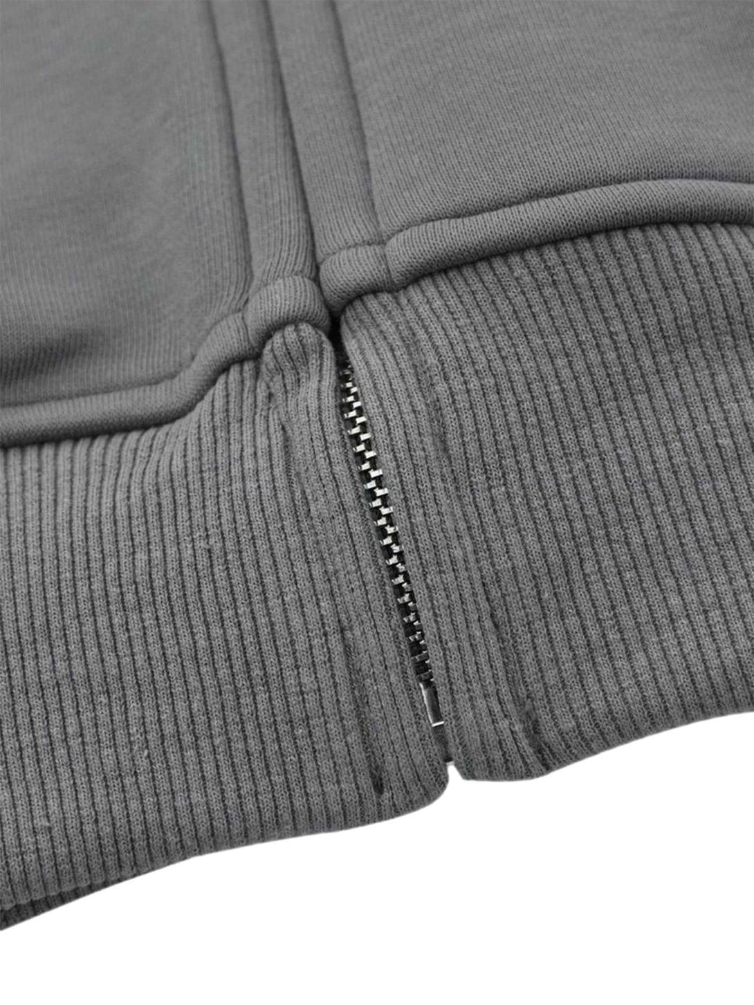Focusing on the ribbed hem and zipper detail of the TALISHKO hooded sweatshirt.