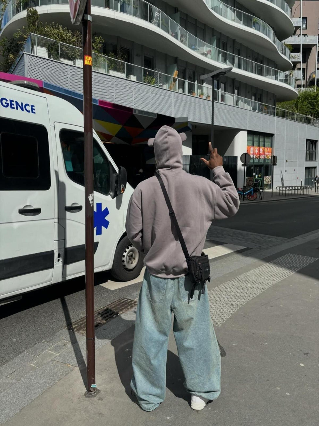 Person wearing TALISHKO hooded sweatshirt with star embroidery, paired with wide-leg jeans.