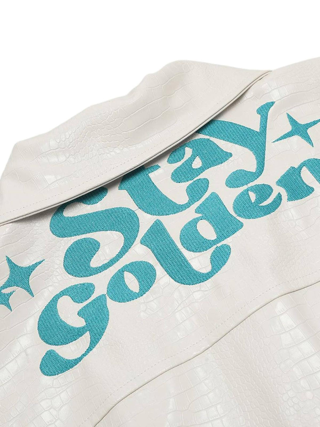 Back view of TALISHKO PU leather jacket with blue "Stay Golden" embroidery and a textured pattern.