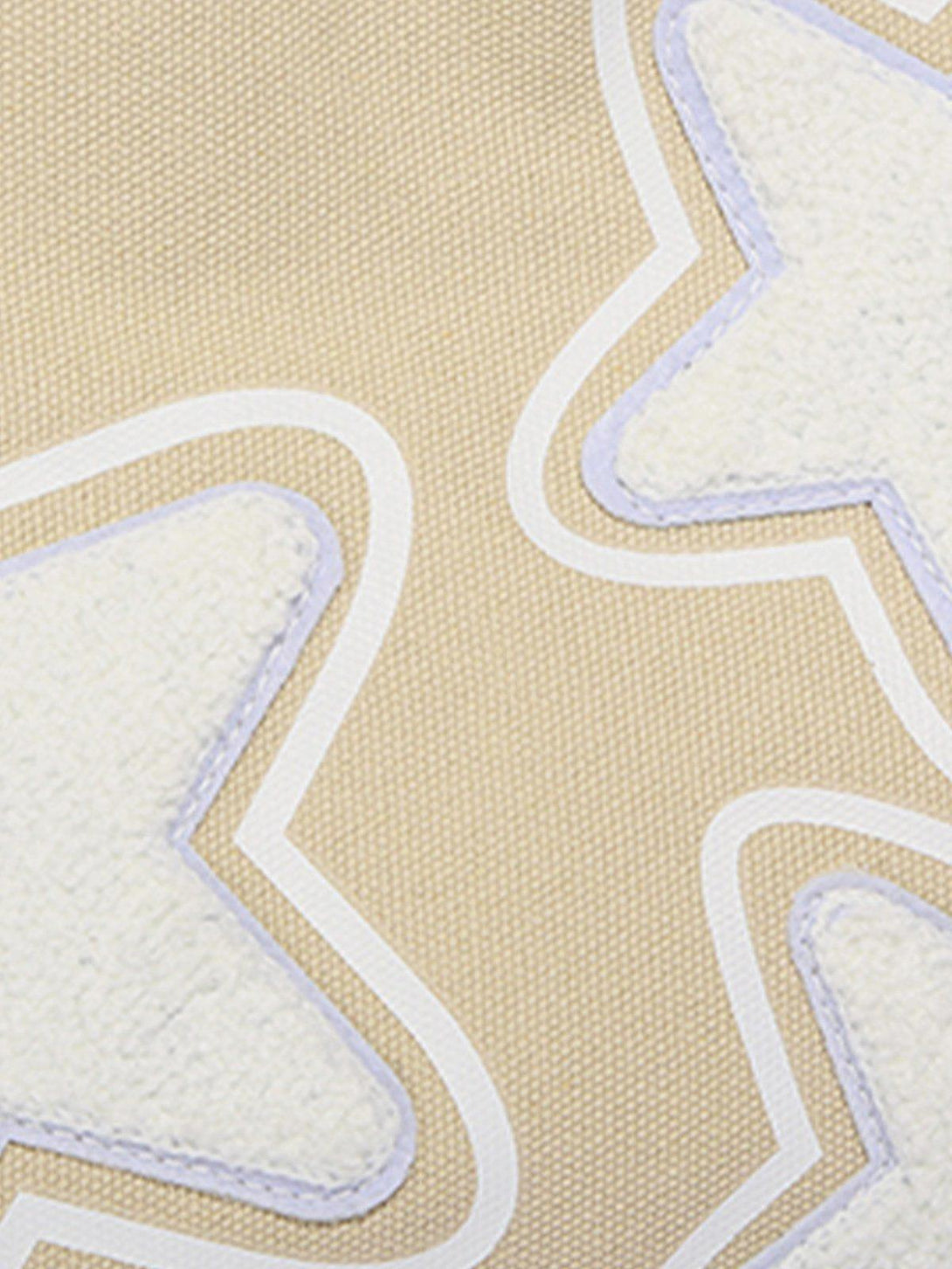 Intricate look at TALISHKO's star graphic tote bag, highlighting textured star patterns.
