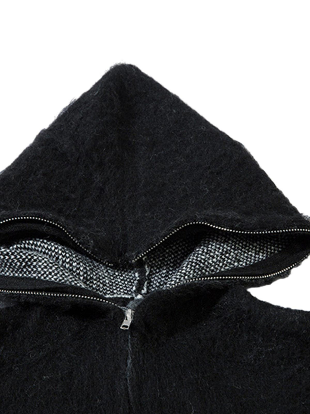 Focusing on the texture of a black hooded zip-up sweater by TALISHKO, highlighting its fuzzy mohair fabric.