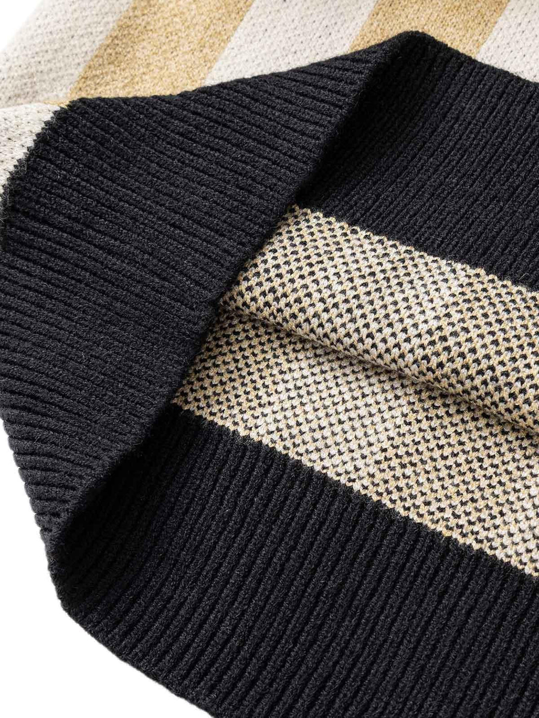 Texture and pattern showcased in a TALISHKO striped sweater, highlighting intricate knit details.