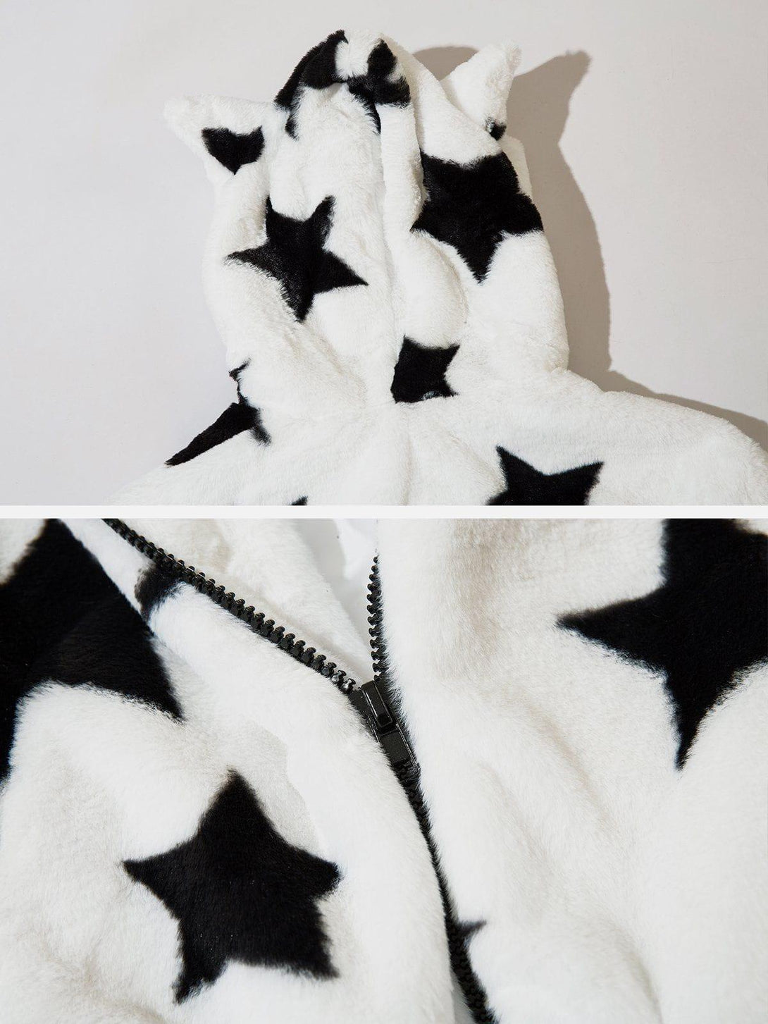 Detailed view of TALISHKO's white hoodie with black stars and playful ear accents on the hood.
