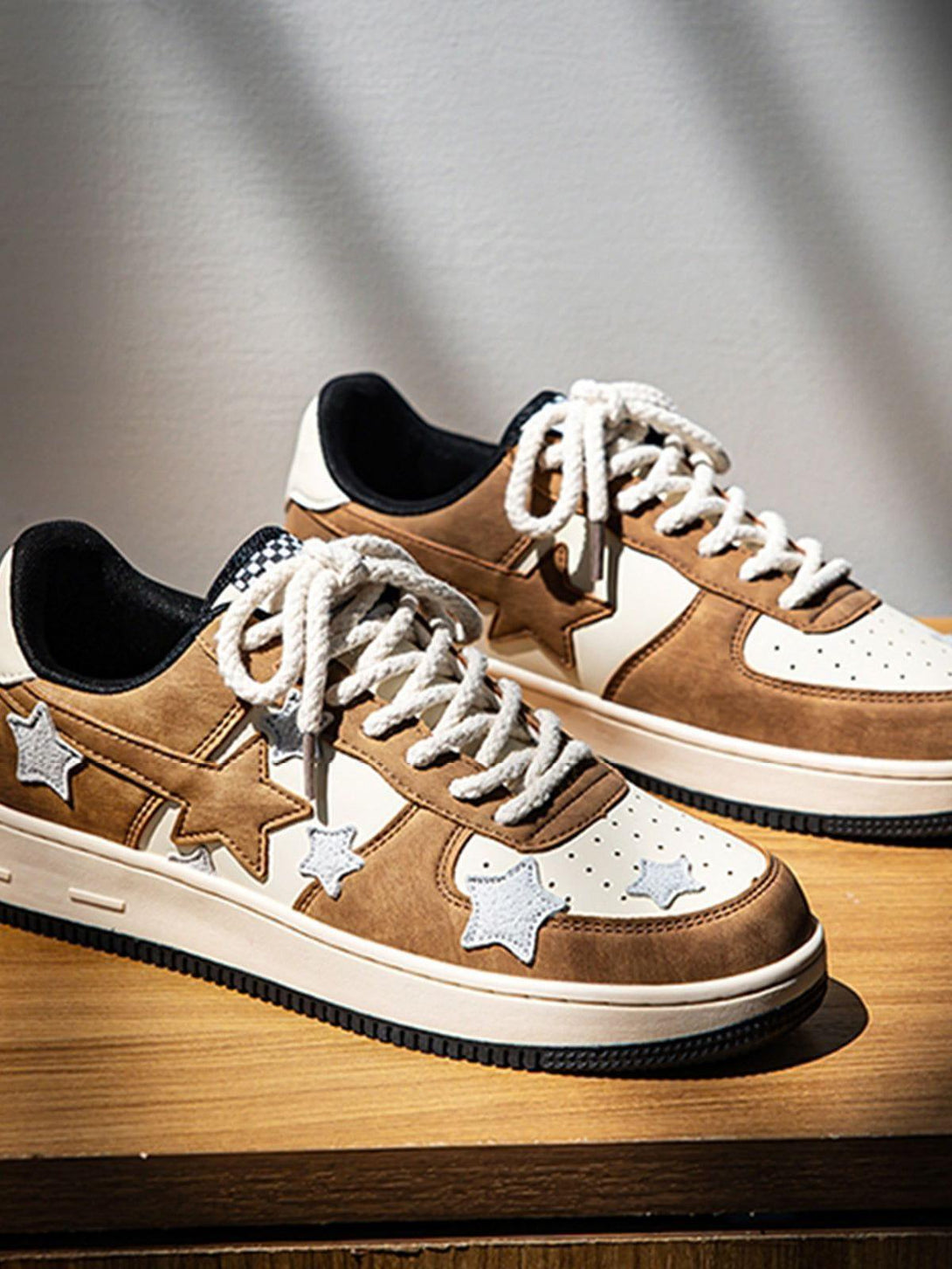 TALISHKO star skate shoes in brown with white star accents, showcased on a wooden surface.