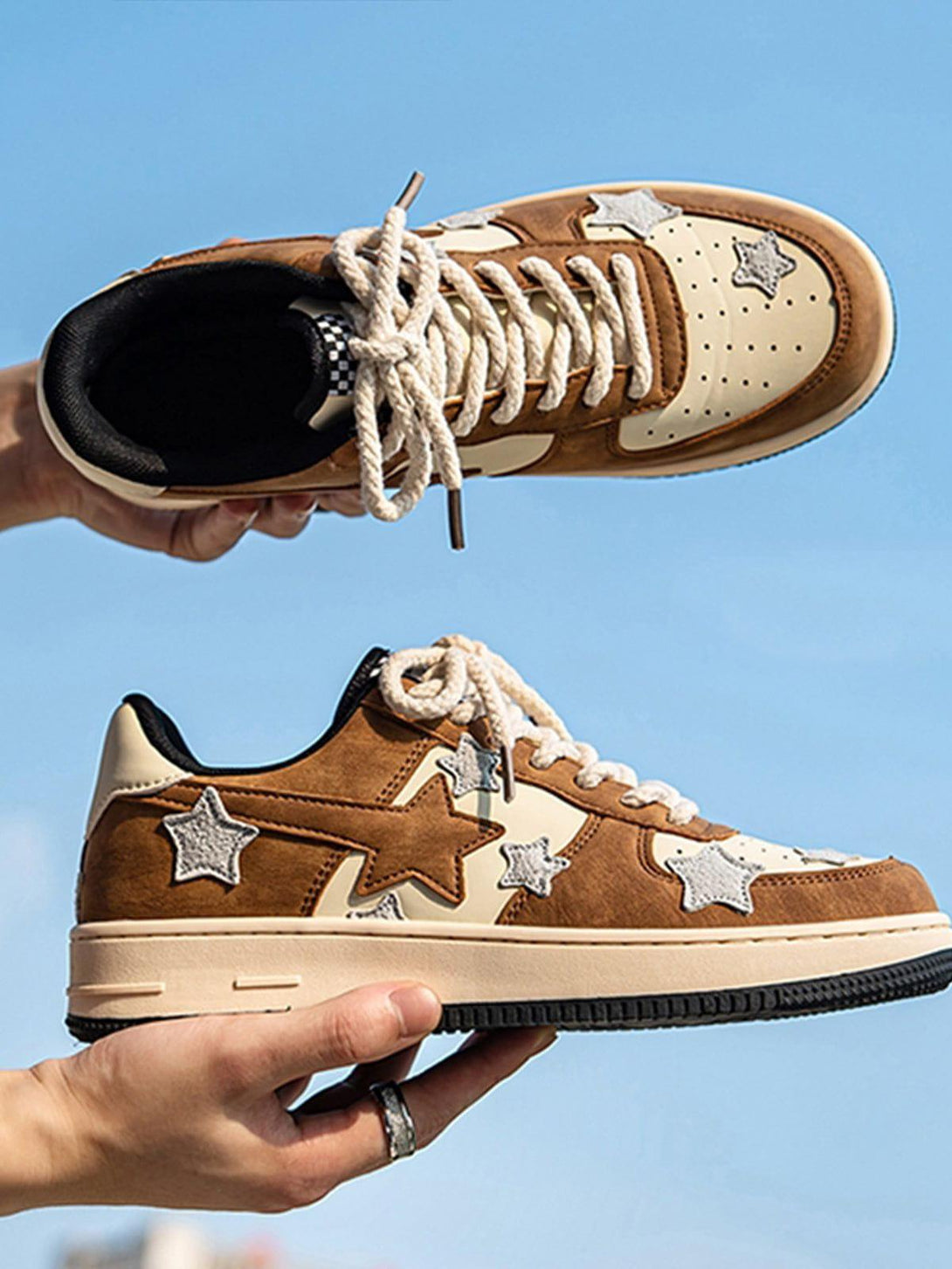 Brown star skate shoes by TALISHKO, shown in a detailed view against a clear blue sky.