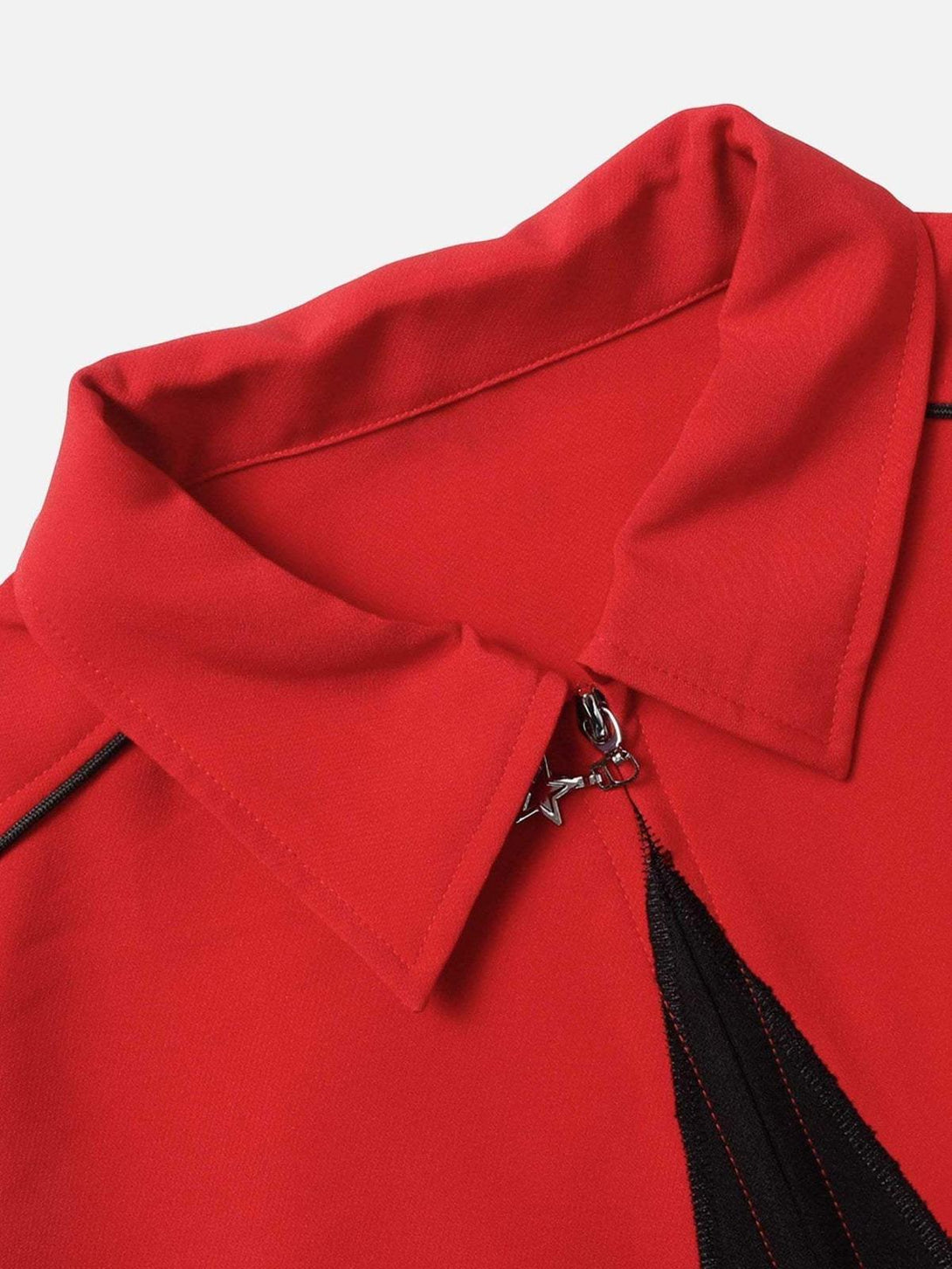 Detailed look at TALISHKO's red shirt collar with star zipper and black piping accents.