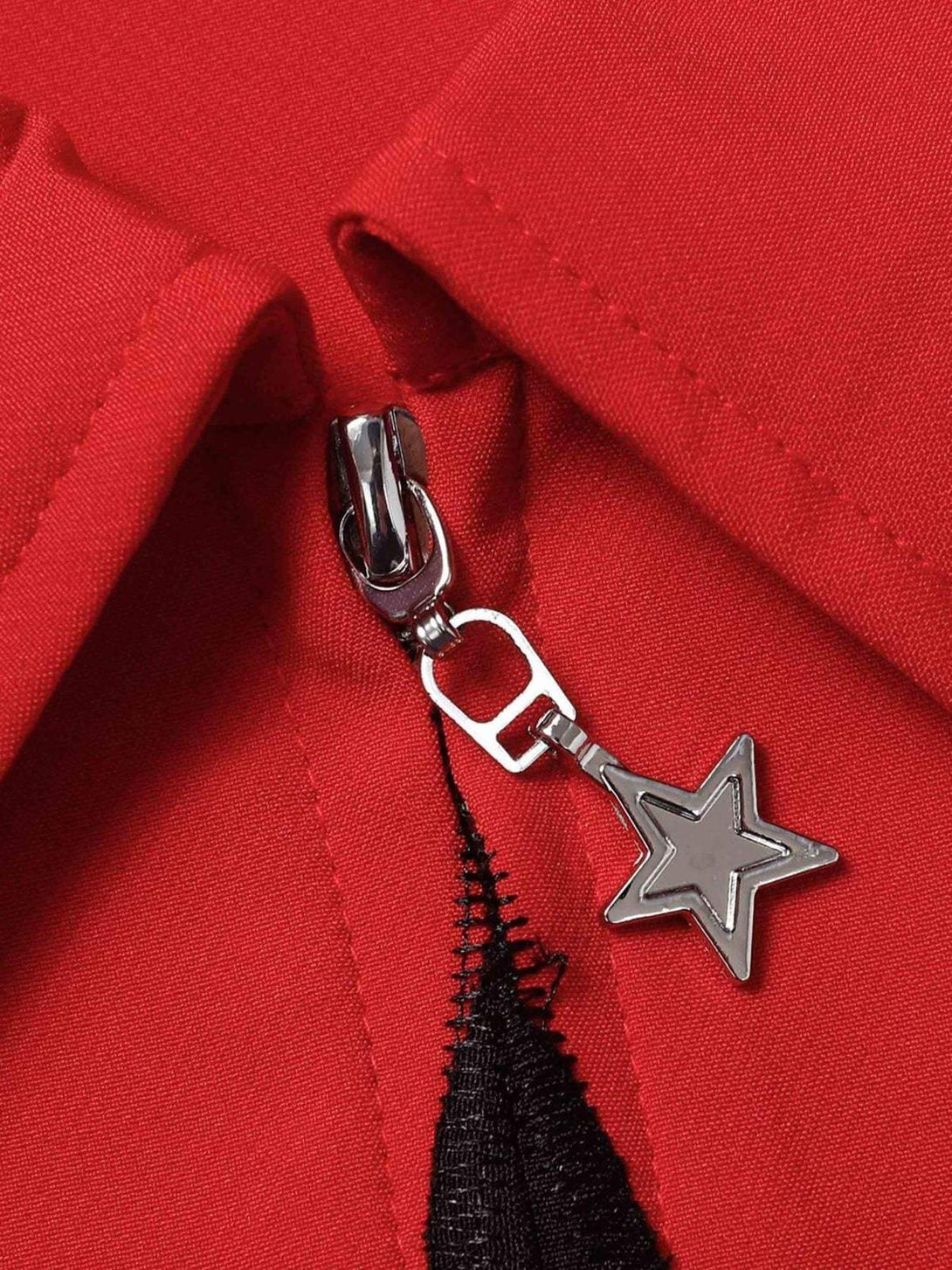 Intricate look at TALISHKO's red shirt zipper with star detail, showcasing unique design.