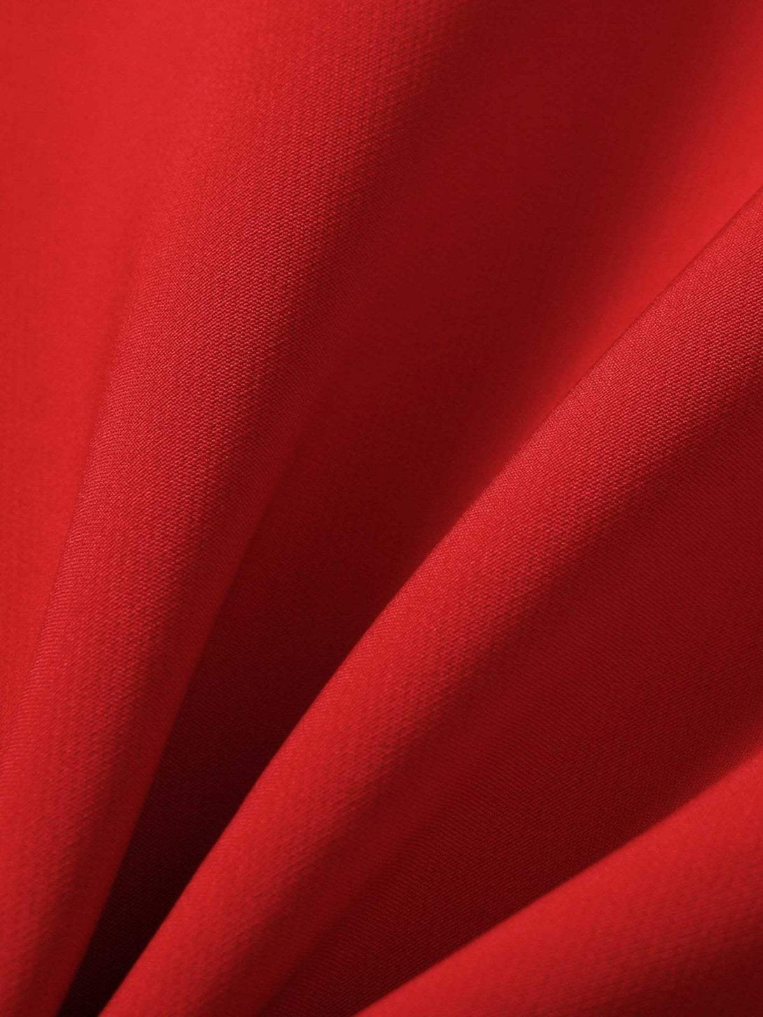 A tight crop highlighting TALISHKO's red fabric texture and quality craftsmanship.