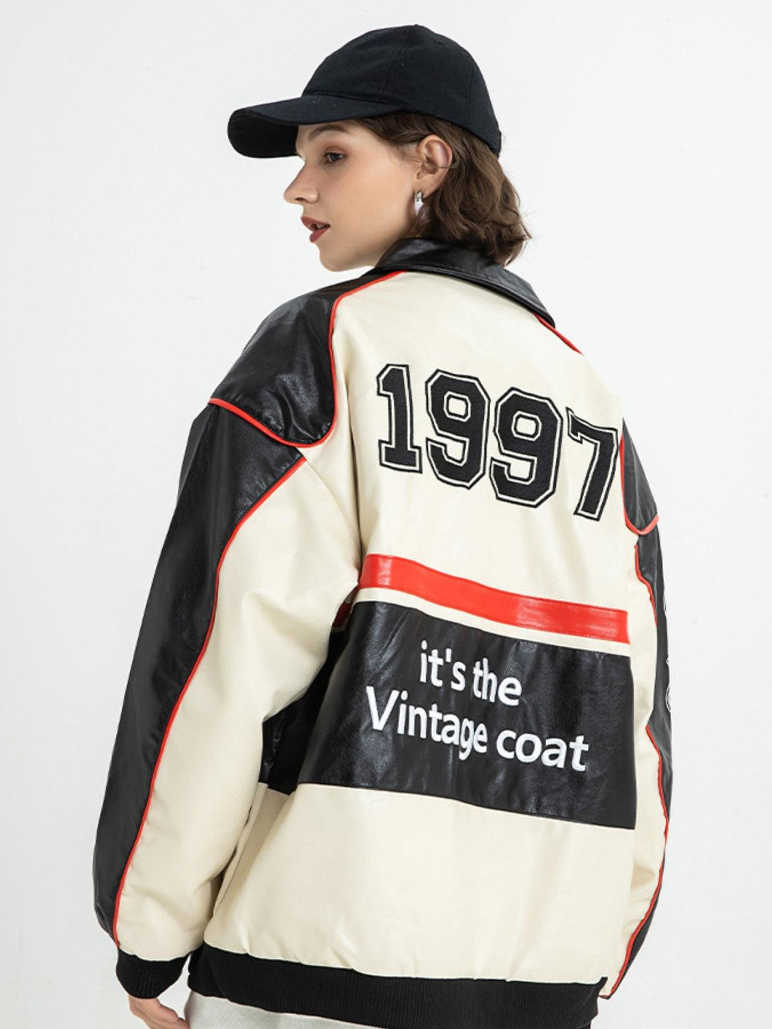 Model in a retro-style motorcycle jacket by TALISHKO, showcasing vintage graphics and bold stitching.