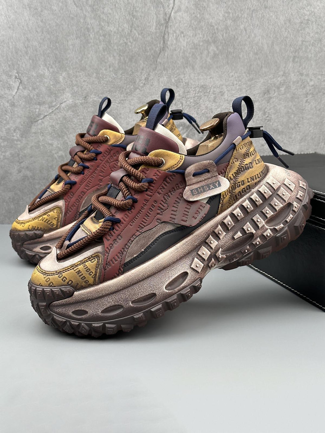 TALISHKO platform sneakers with rugged tire soles, featuring intricate lettering and stitching.